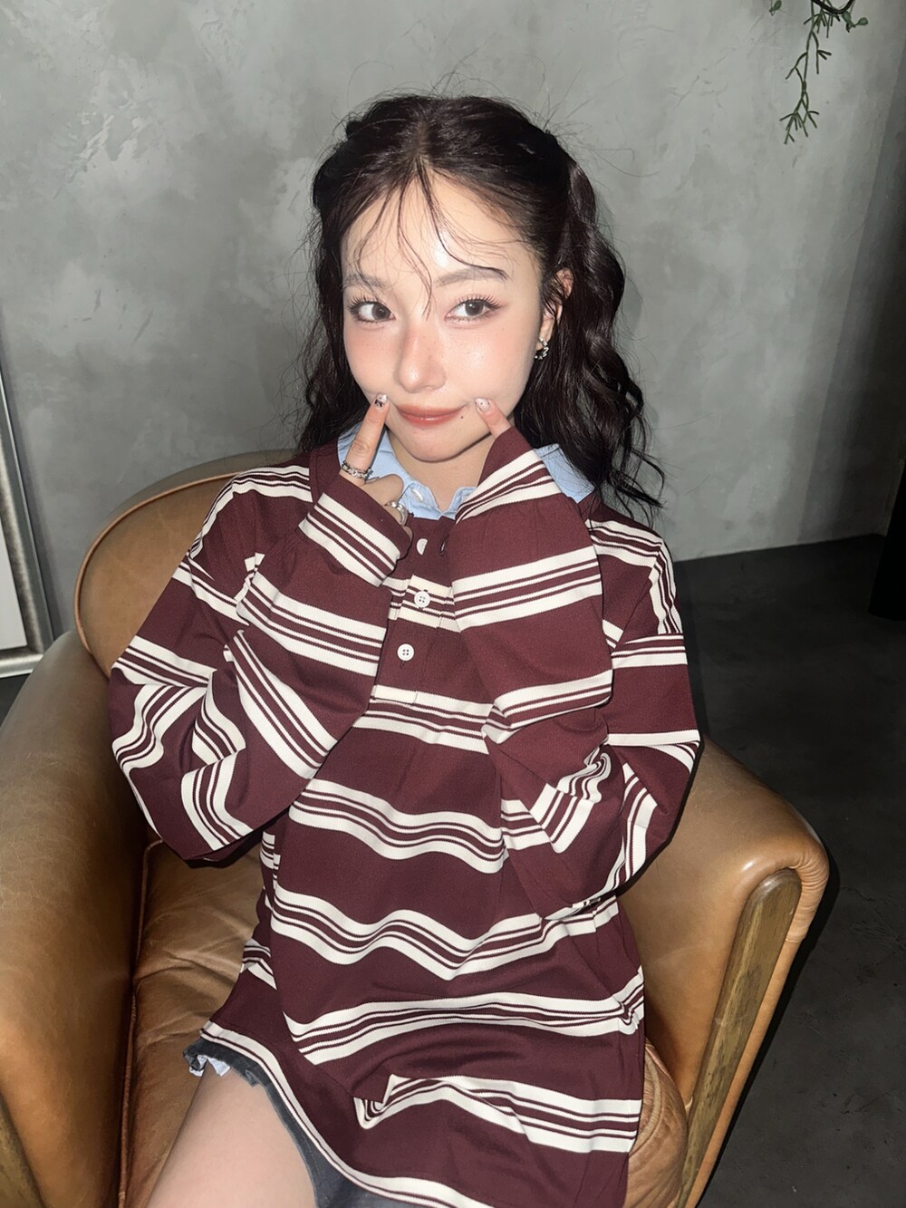 レッド系のポロシャツを着用したレディースの秋コーディネートの3枚目の写真