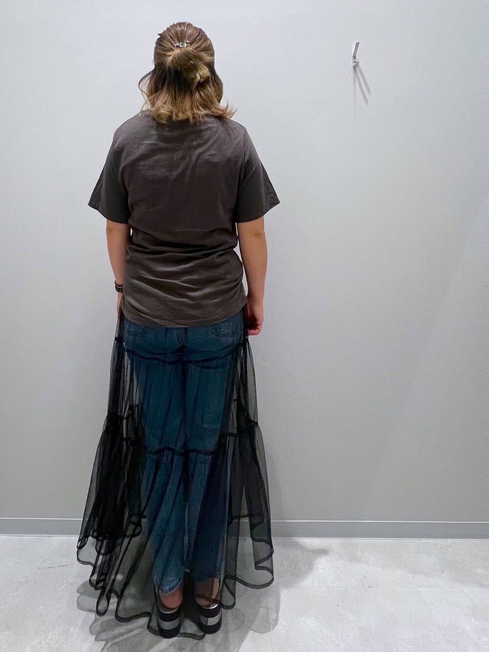 グレー系のTシャツ/カットソー、ブルー系のデニムパンツ、ブラック系のスカートを着用したレディースの夏コーディネートの3枚目の写真