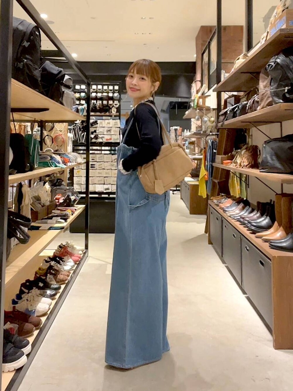 ブラック系のカーディガン/ボレロ、ベージュ系のボストンバッグを着用したレディースの秋コーディネートの3枚目の写真