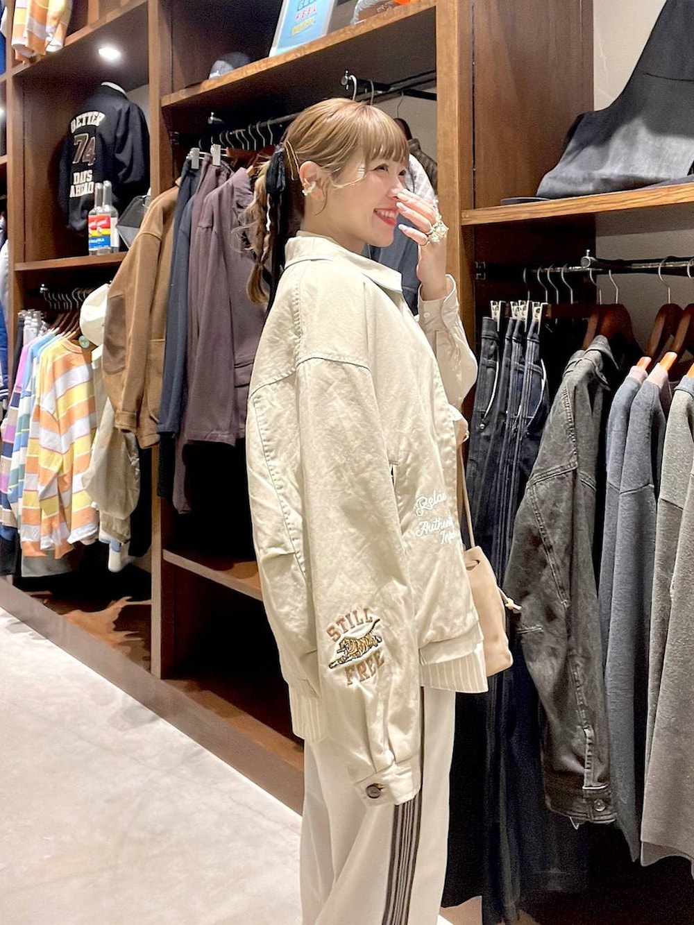 ベージュ系のシャツ/ブラウス、ベージュ系のショルダーバッグ、ベージュ系のスニーカーを着用したレディースの冬コーディネートの5枚目の写真