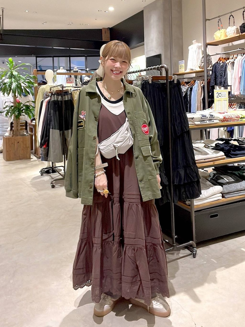 ピンク系のデニムパンツ、ホワイト系のタンクトップ、イエロー系のブレスレットを着用したレディースの春コーディネートの6枚目の写真