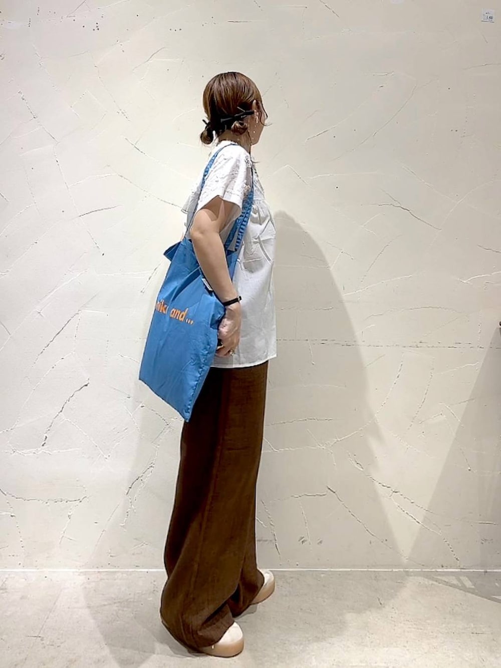 ブルー系のトートバッグ、ホワイト系のシャツ/ブラウス、ブラウン系のその他パンツを着用したレディースの夏コーディネートの4枚目の写真