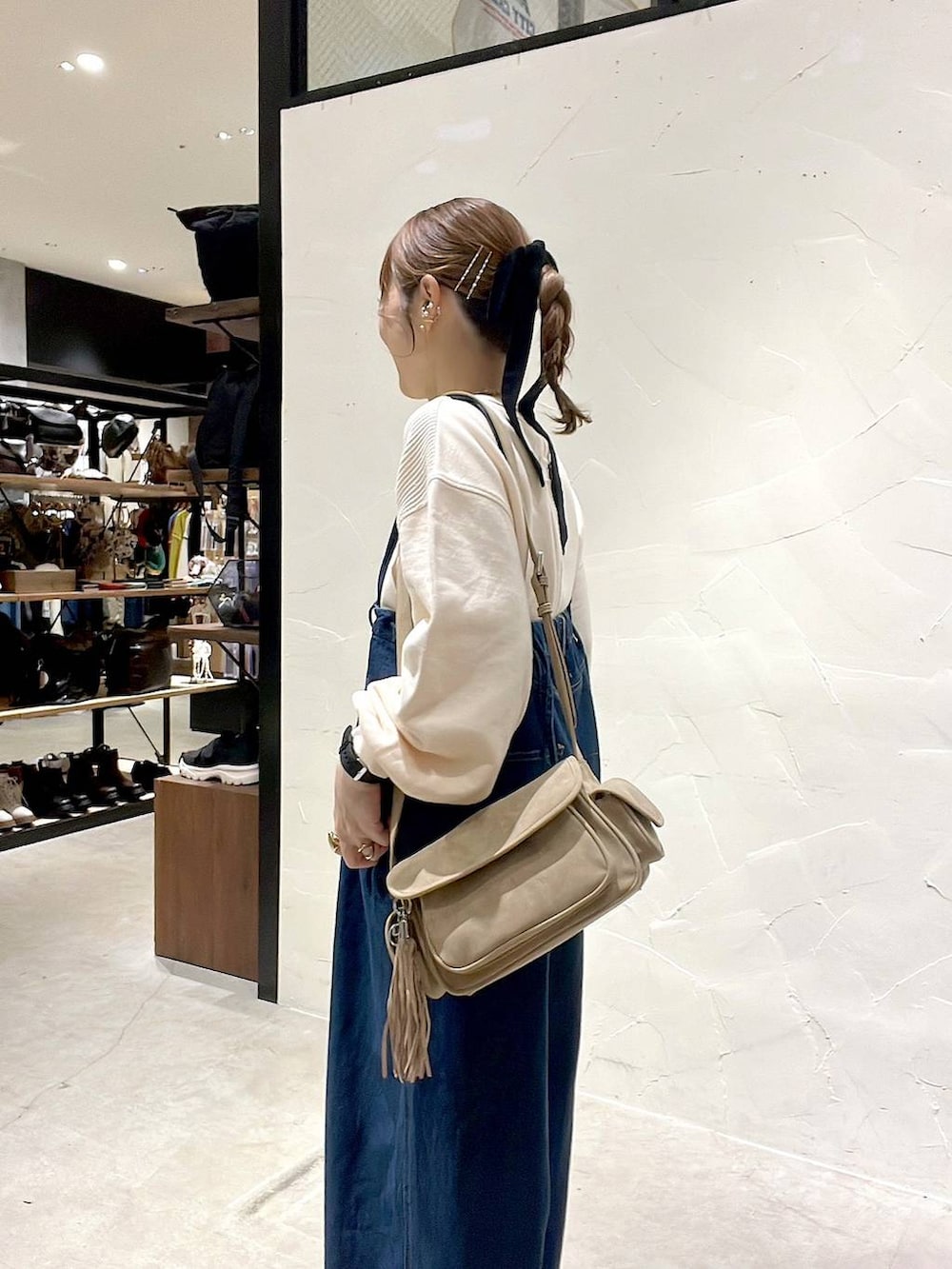 ベージュ系のショルダーバッグ、ブラック系のアナログ腕時計を着用したレディースの秋コーディネートの6枚目の写真