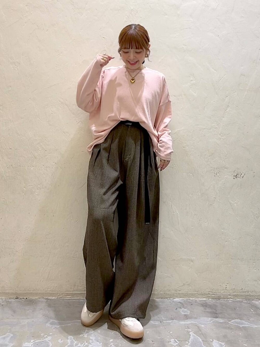 ブラウン系のその他パンツ、ピンク系のTシャツ/カットソー、イエロー系のリングを着用したレディースの冬コーディネートの4枚目の写真