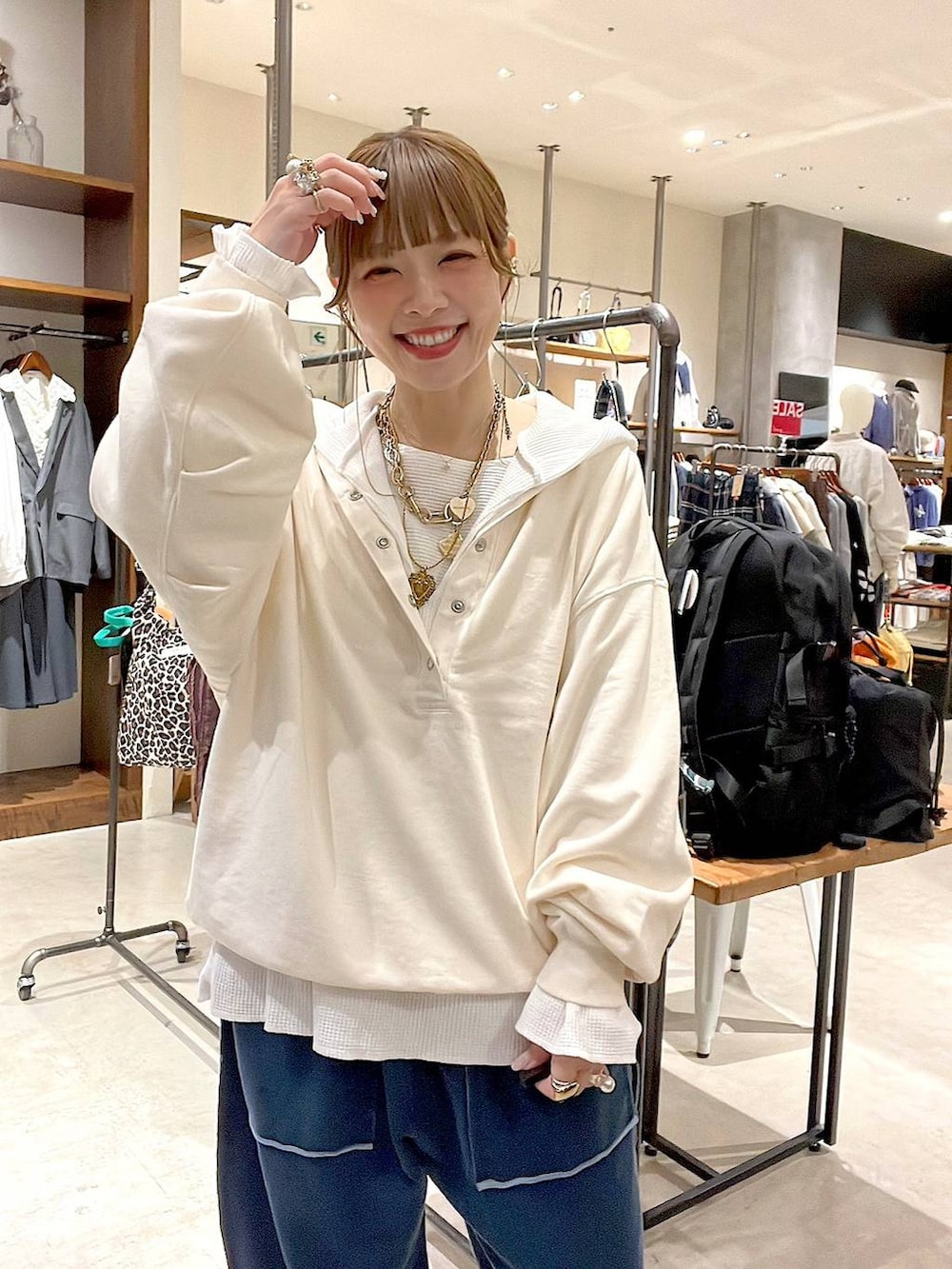 ベージュ系のショルダーバッグ、ホワイト系のパーカー、ホワイト系のTシャツ/カットソーを着用したレディースの冬コーディネートの7枚目の写真