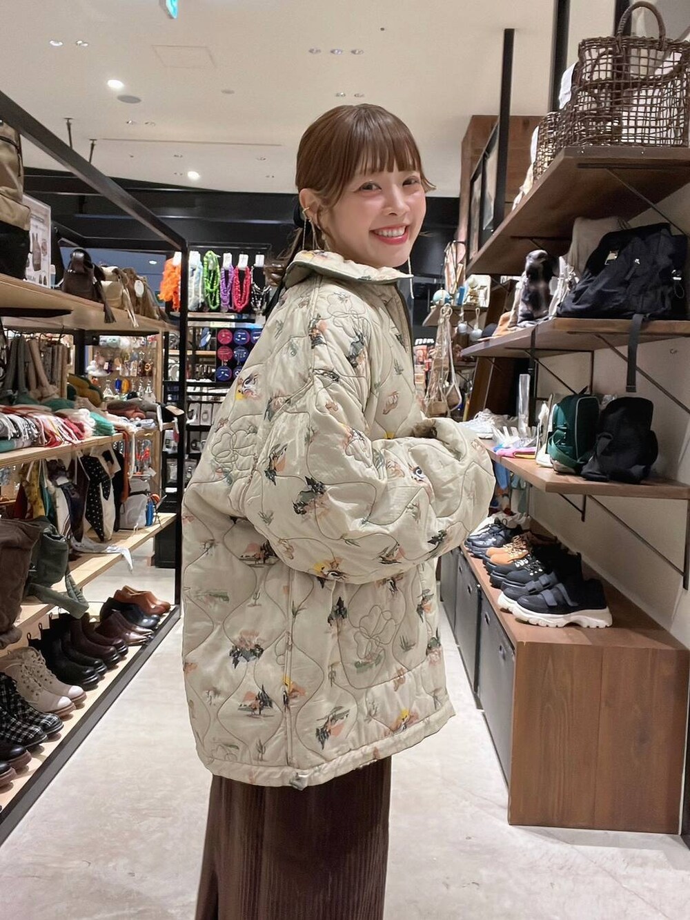 グリーン系のその他アウター、ベージュ系のニット/セーター、ゴールド系のネックレスを着用したレディースの秋コーディネートの4枚目の写真