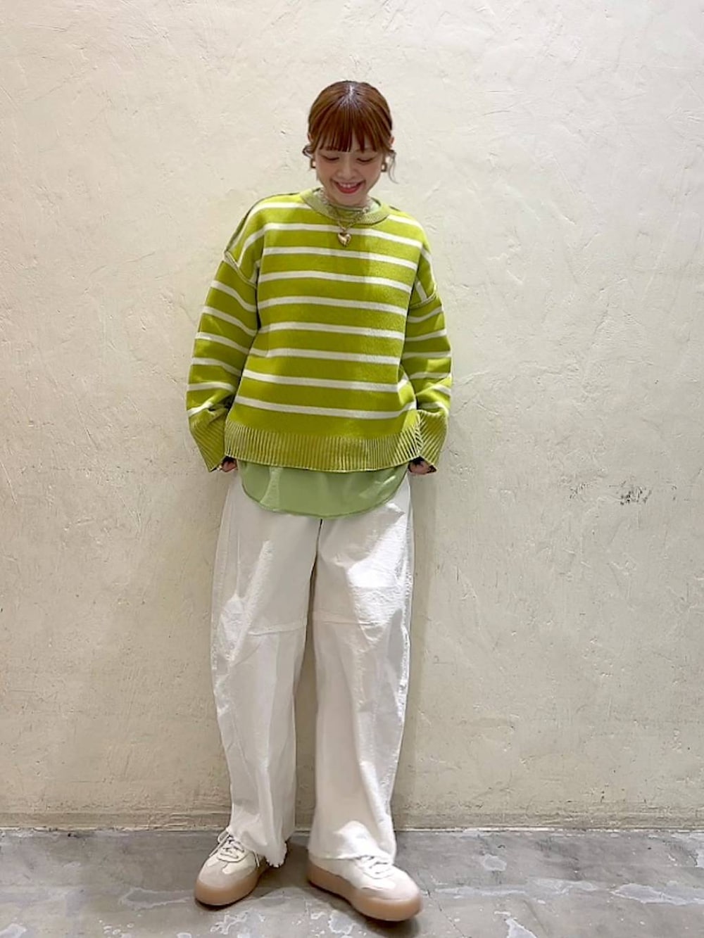 ホワイト系のその他パンツ、シルバー系のショルダーバッグ、イエロー系のニット/セーターを着用したレディースの冬コーディネートの2枚目の写真