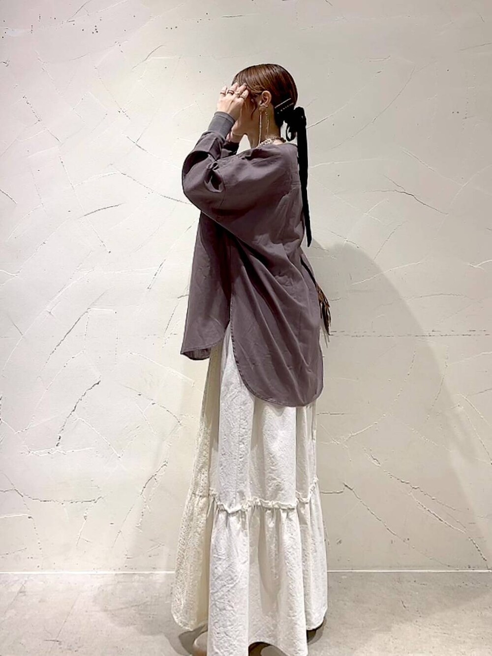 ベージュ系のスカート、ブラウン系のショルダーバッグ、ベージュ系のネックレスを着用したレディースの夏コーディネートの7枚目の写真