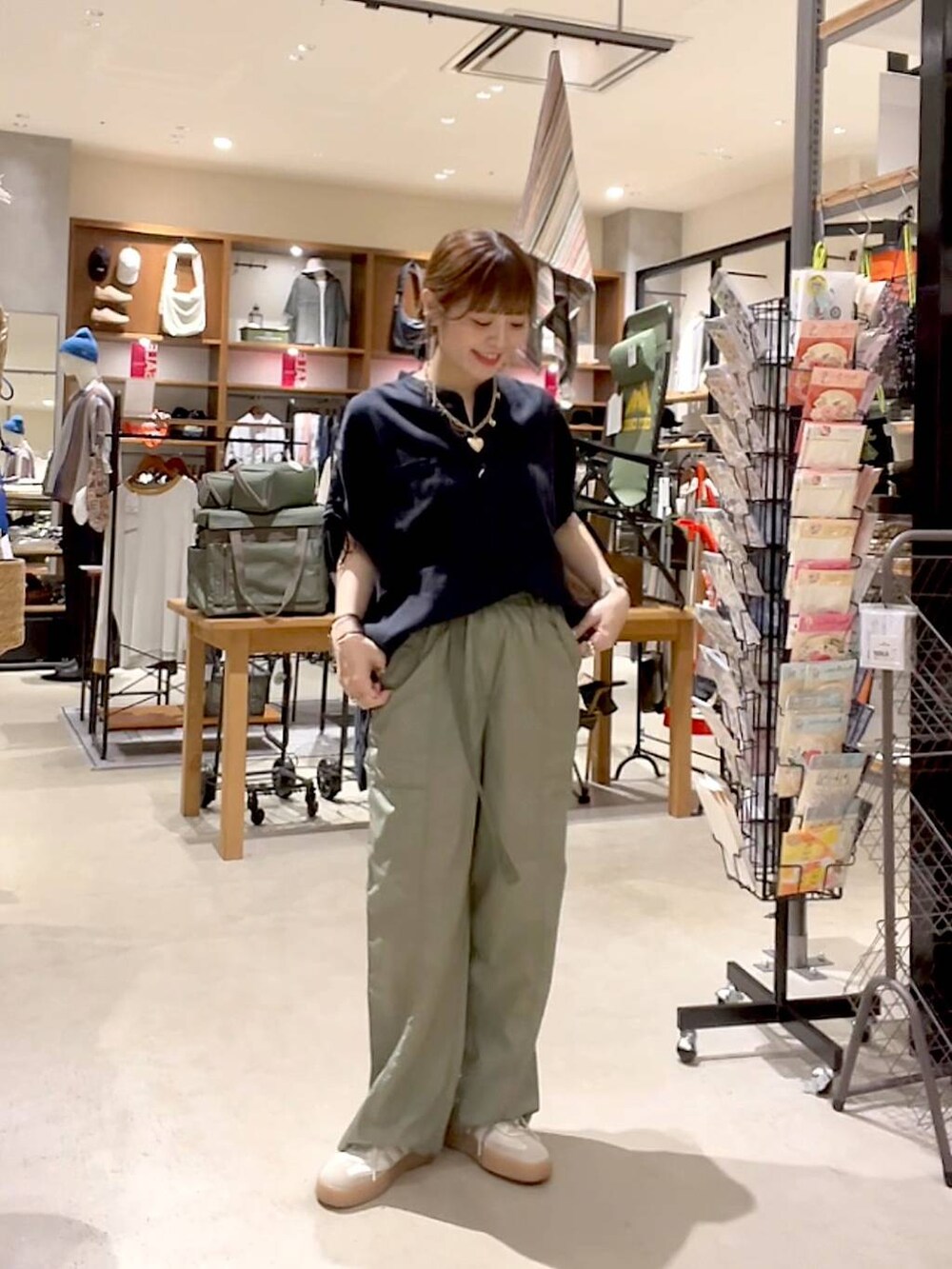 ブラック系のシャツ/ブラウス、グリーン系のその他パンツ、ゴールド系のネックレスを着用したレディースの夏コーディネートの3枚目の写真