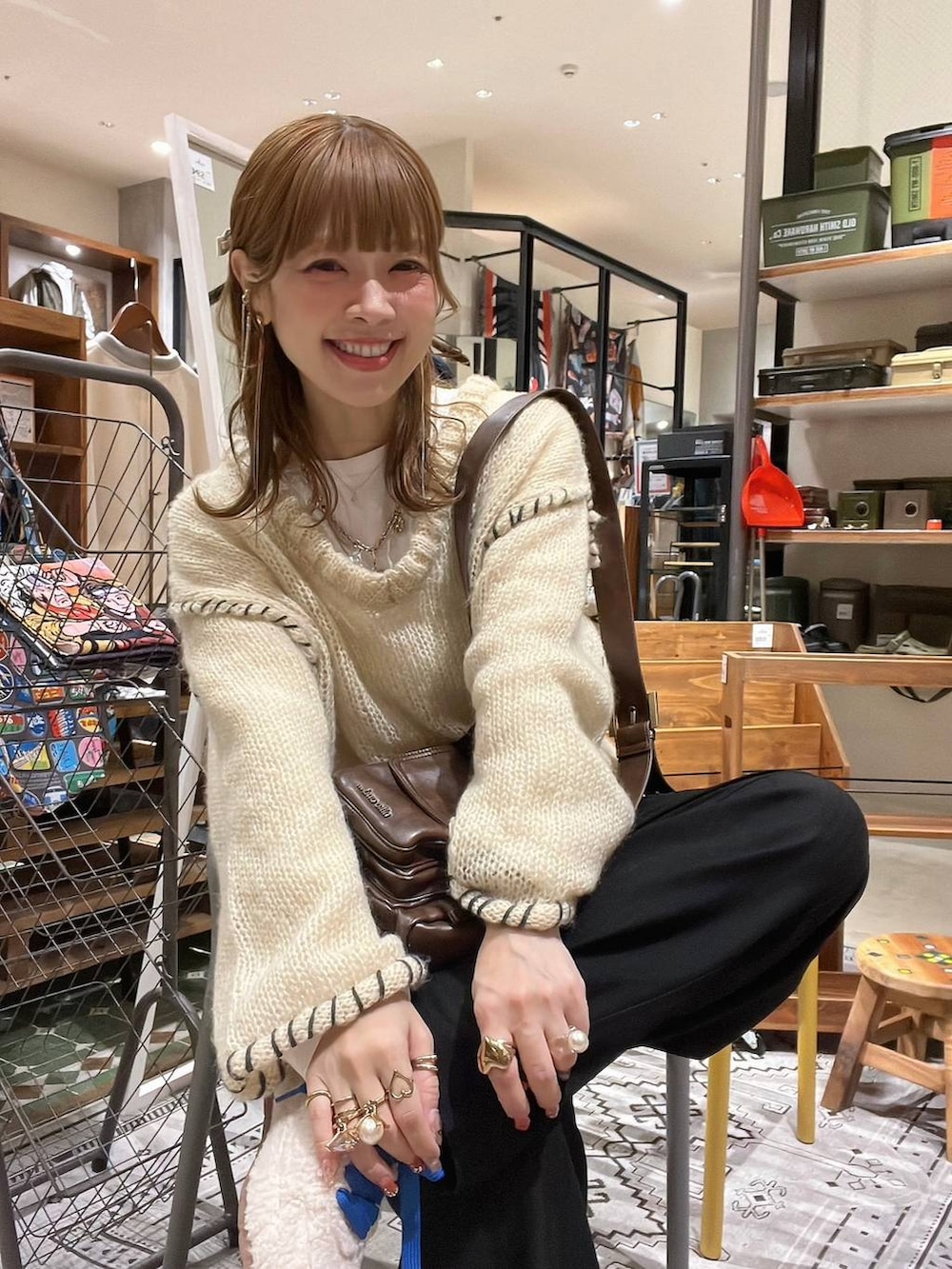 ホワイト系のTシャツ/カットソー、ブラウン系のショルダーバッグ、ベージュ系のスニーカーを着用したレディースの冬コーディネートの6枚目の写真