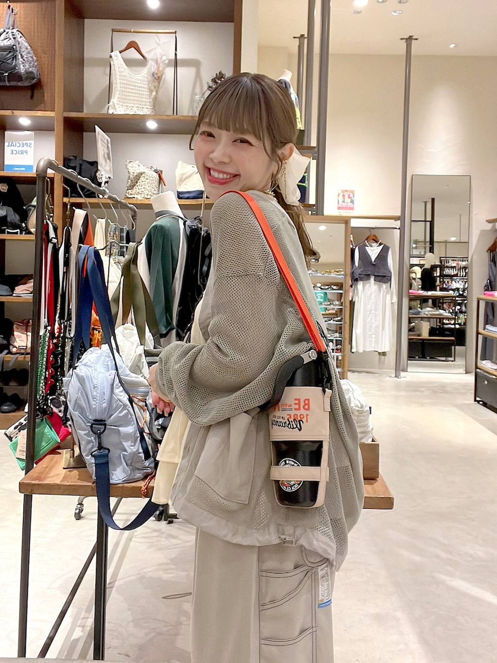 ホワイト系のタンクトップ、ベージュ系のスカート、ピンク系のネックレスを着用したレディースの春コーディネートの3枚目の写真