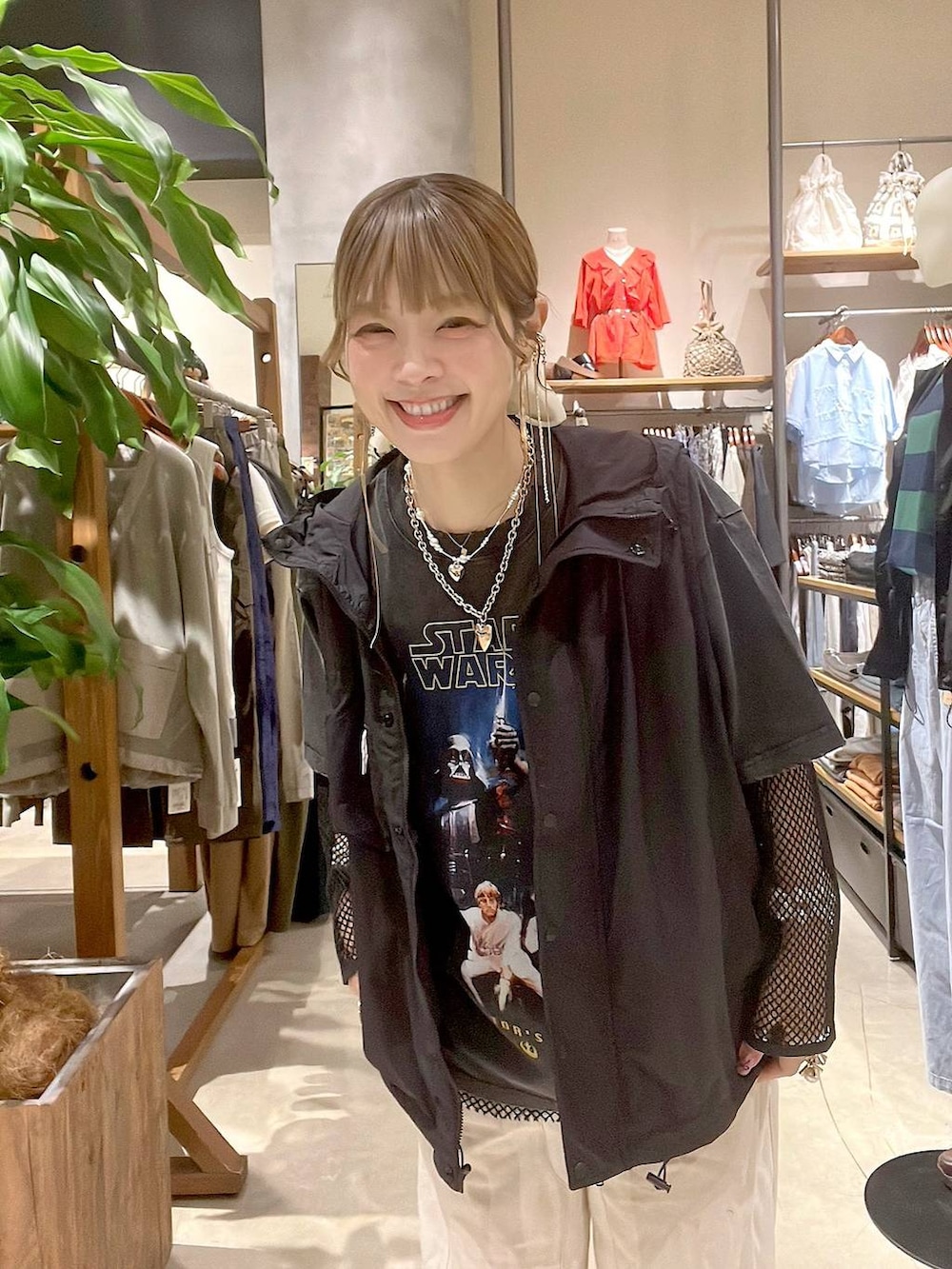 ベージュ系のデニムパンツ、ブラック系のベスト、ブラック系のTシャツ/カットソーを着用したレディースの春コーディネートの2枚目の写真