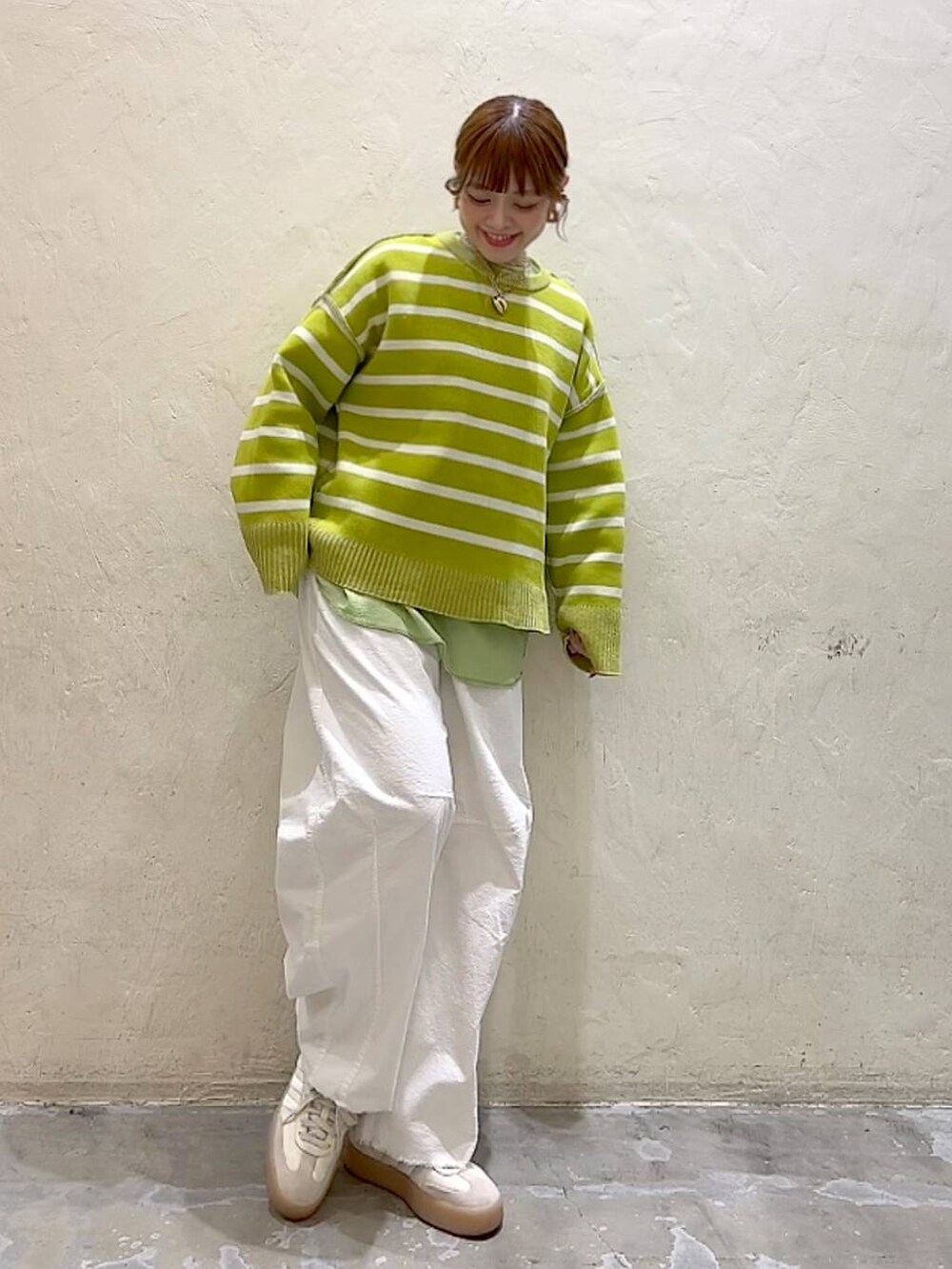 ホワイト系のその他パンツ、シルバー系のショルダーバッグ、イエロー系のニット/セーターを着用したレディースの冬コーディネートの8枚目の写真