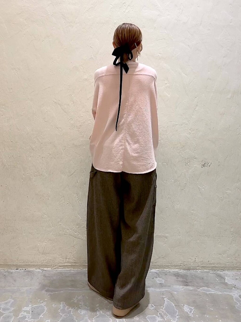 ブラウン系のその他パンツ、ピンク系のTシャツ/カットソー、イエロー系のリングを着用したレディースの冬コーディネートの6枚目の写真