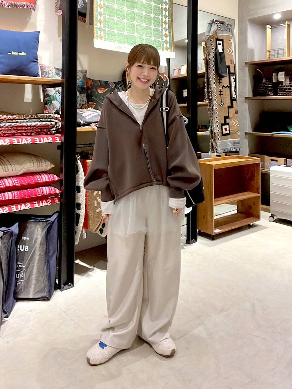 ブラック系のショルダーバッグ、ベージュ系のスニーカー、ベージュ系のその他パンツを着用したレディースの冬コーディネートの8枚目の写真