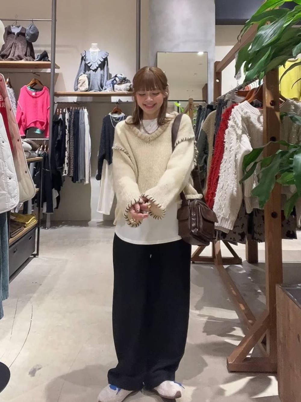 ホワイト系のTシャツ/カットソー、ブラウン系のショルダーバッグ、ベージュ系のスニーカーを着用したレディースの冬コーディネートの9枚目の写真