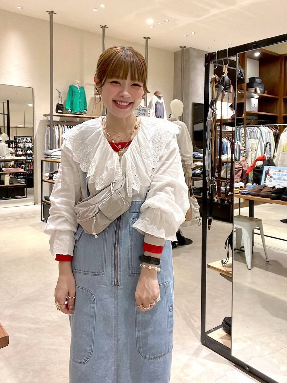 ブルー系のジャンパースカート、ベージュ系のTシャツ/カットソー、ホワイト系のシャツ/ブラウスを着用したレディースの冬コーディネートの8枚目の写真