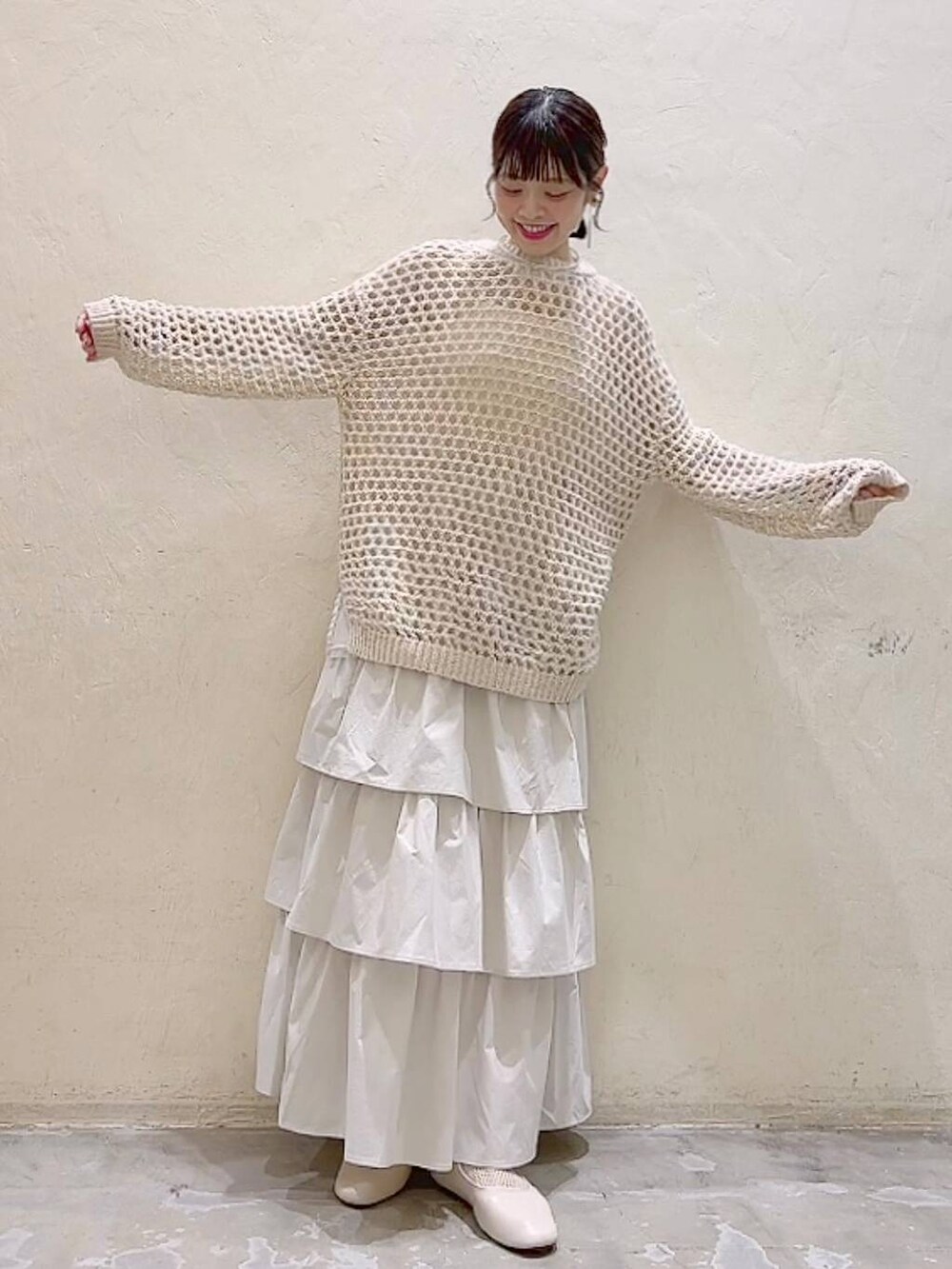 ホワイト系のパンプス、ベージュ系のニット/セーター、ベージュ系のスカートを着用したレディースの冬コーディネートの6枚目の写真