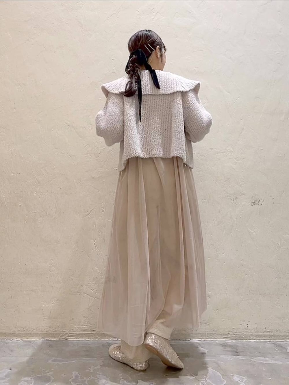 ベージュ系のワンピース、ホワイト系のその他パンツ、ホワイト系のバレエシューズを着用したレディースの冬コーディネートの4枚目の写真