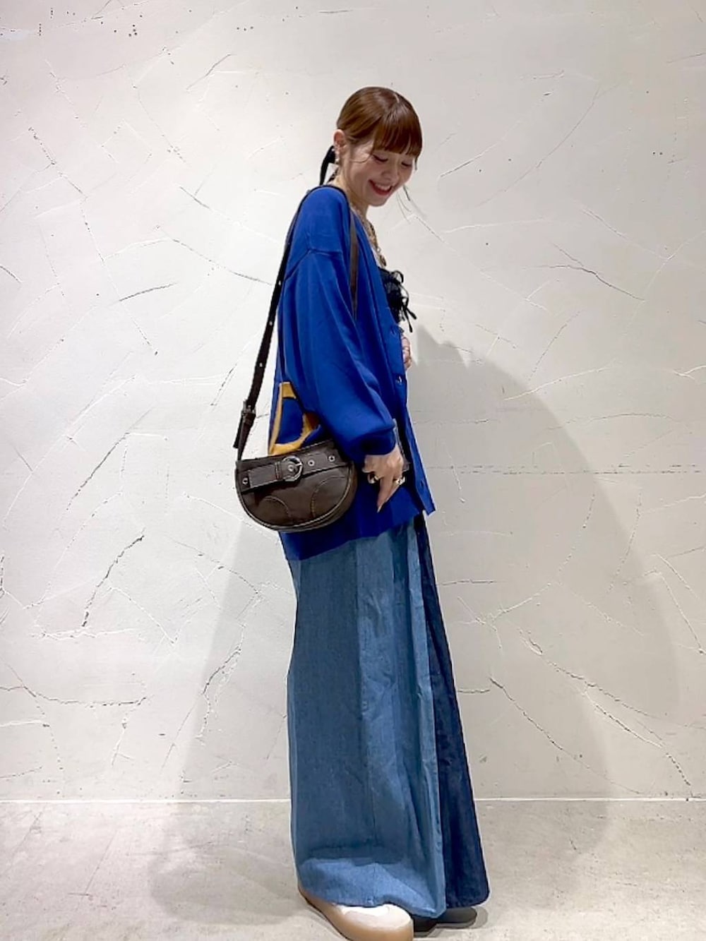 ブラック系のキャミソール、ブラウン系のショルダーバッグを着用したレディースの秋コーディネートの7枚目の写真