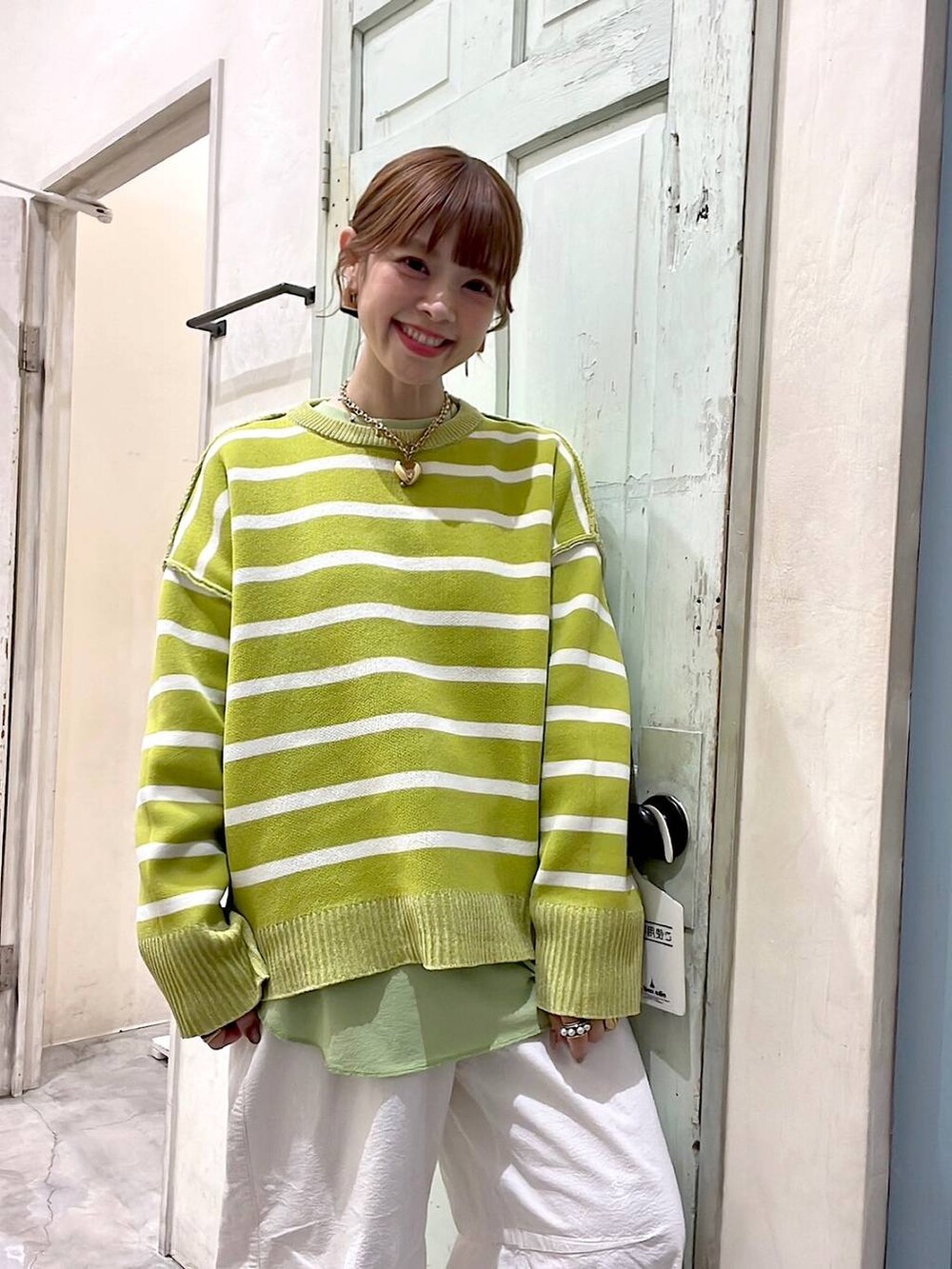 ホワイト系のその他パンツ、シルバー系のショルダーバッグ、イエロー系のニット/セーターを着用したレディースの冬コーディネートの7枚目の写真