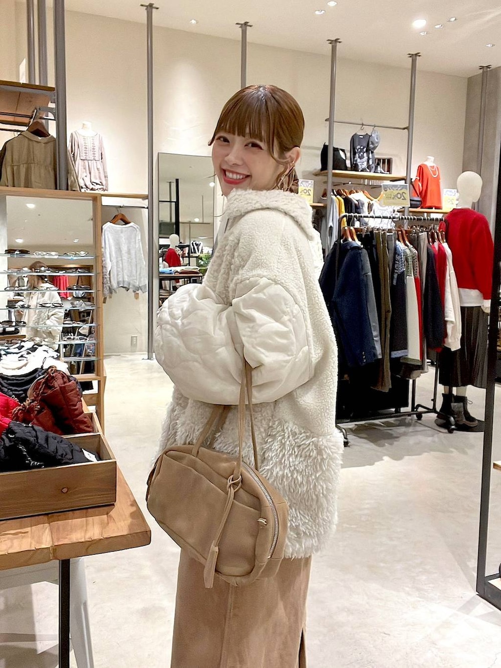 ベージュ系のブルゾン、イエロー系のスカート、ベージュ系のボストンバッグを着用したレディースの秋コーディネートの5枚目の写真