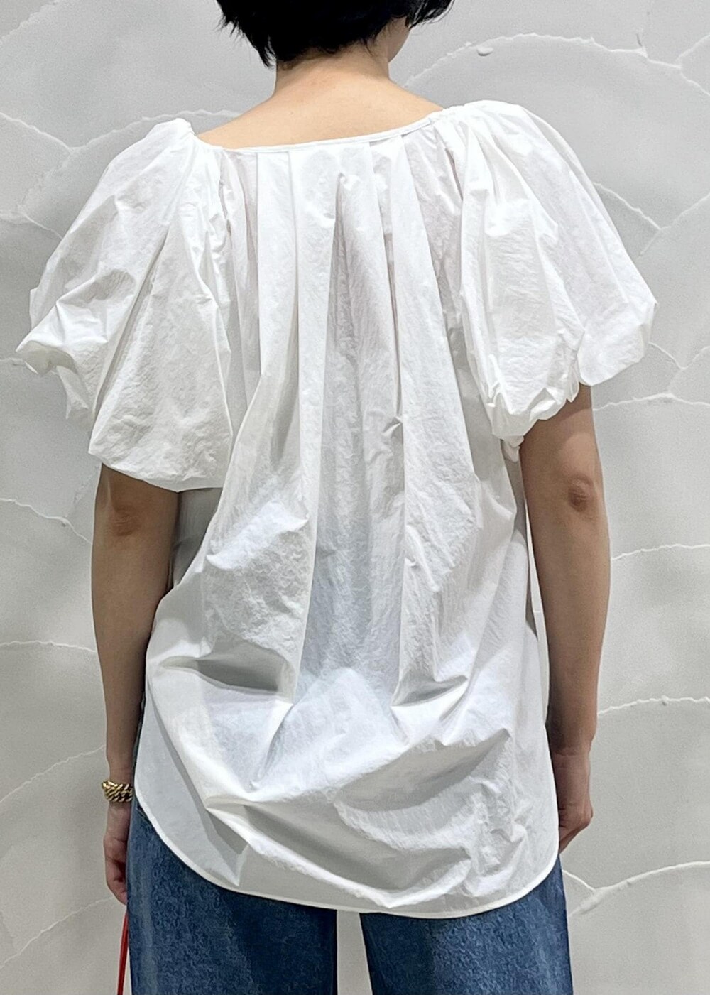 ブルー系のデニムパンツ、ホワイト系のシャツ/ブラウス、ホワイト系のキャミソールを着用したレディースの春コーディネートの5枚目の写真