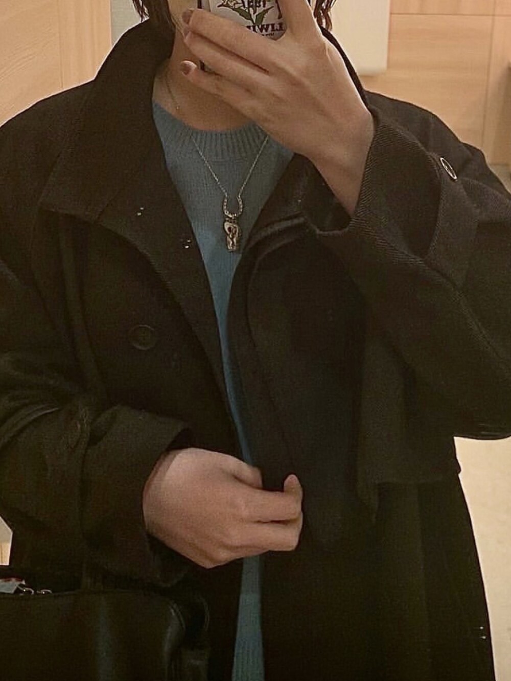 ブラウン系のステンカラーコートを着用したレディースの冬コーディネートの3枚目の写真