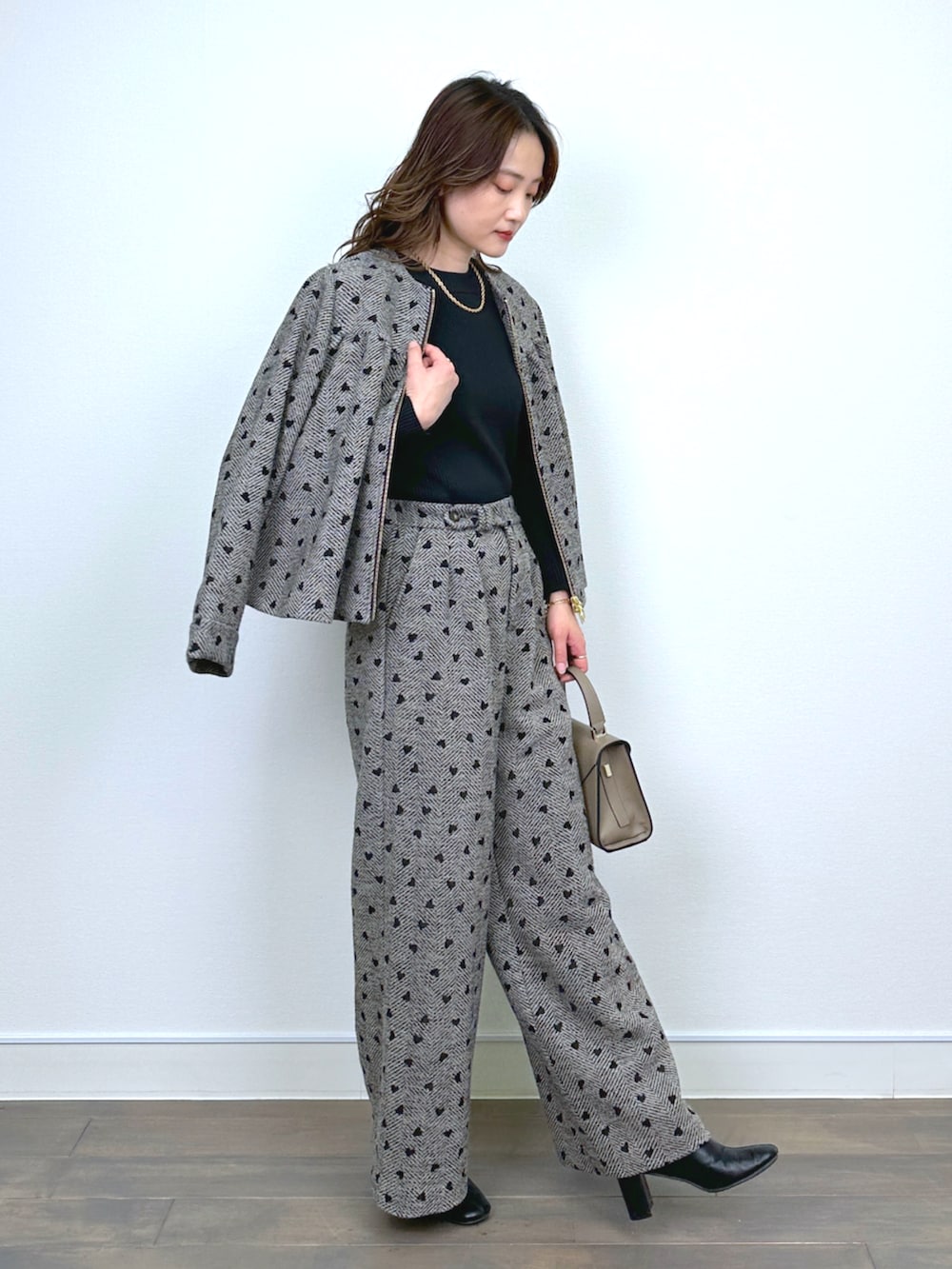 ブラウン系のブルゾン、ブラック系のニット/セーター、ブラウン系のその他パンツを着用したレディースの秋コーディネートの2枚目の写真