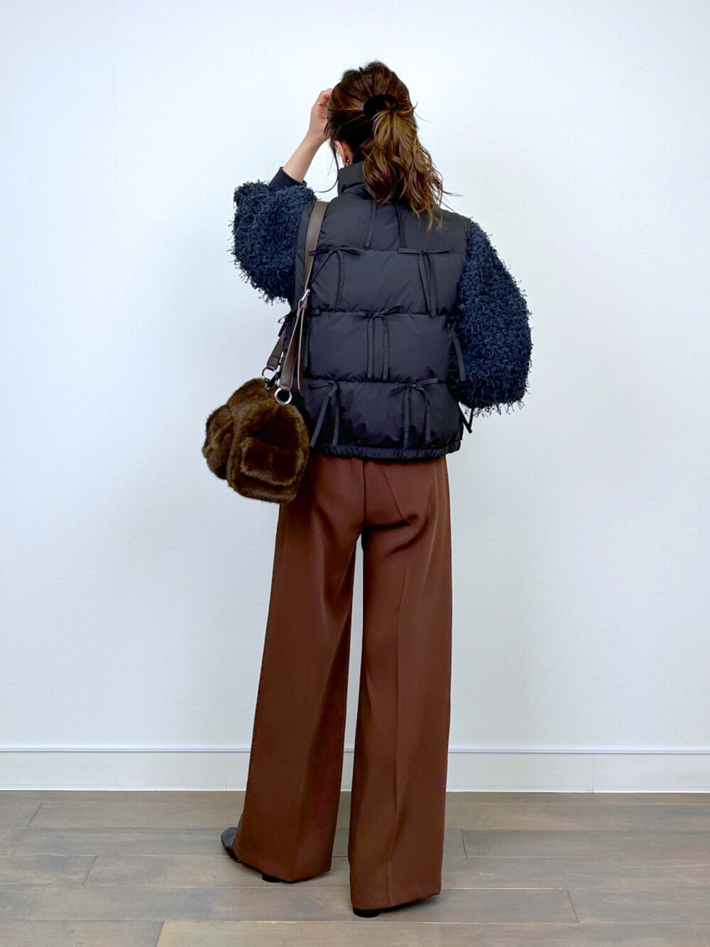 グレー系のTシャツ/カットソー、ブラウン系のスラックスを着用したレディースの冬コーディネートの3枚目の写真