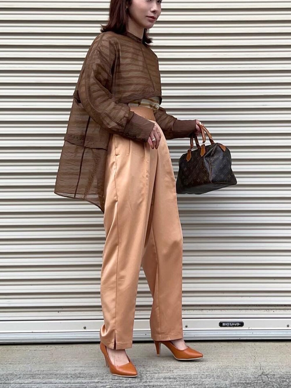 ブラウン系のシャツ/ブラウス、オレンジ系のTシャツ/カットソー、ブラウン系のテーラードジャケットを着用したレディースの春コーディネートの2枚目の写真