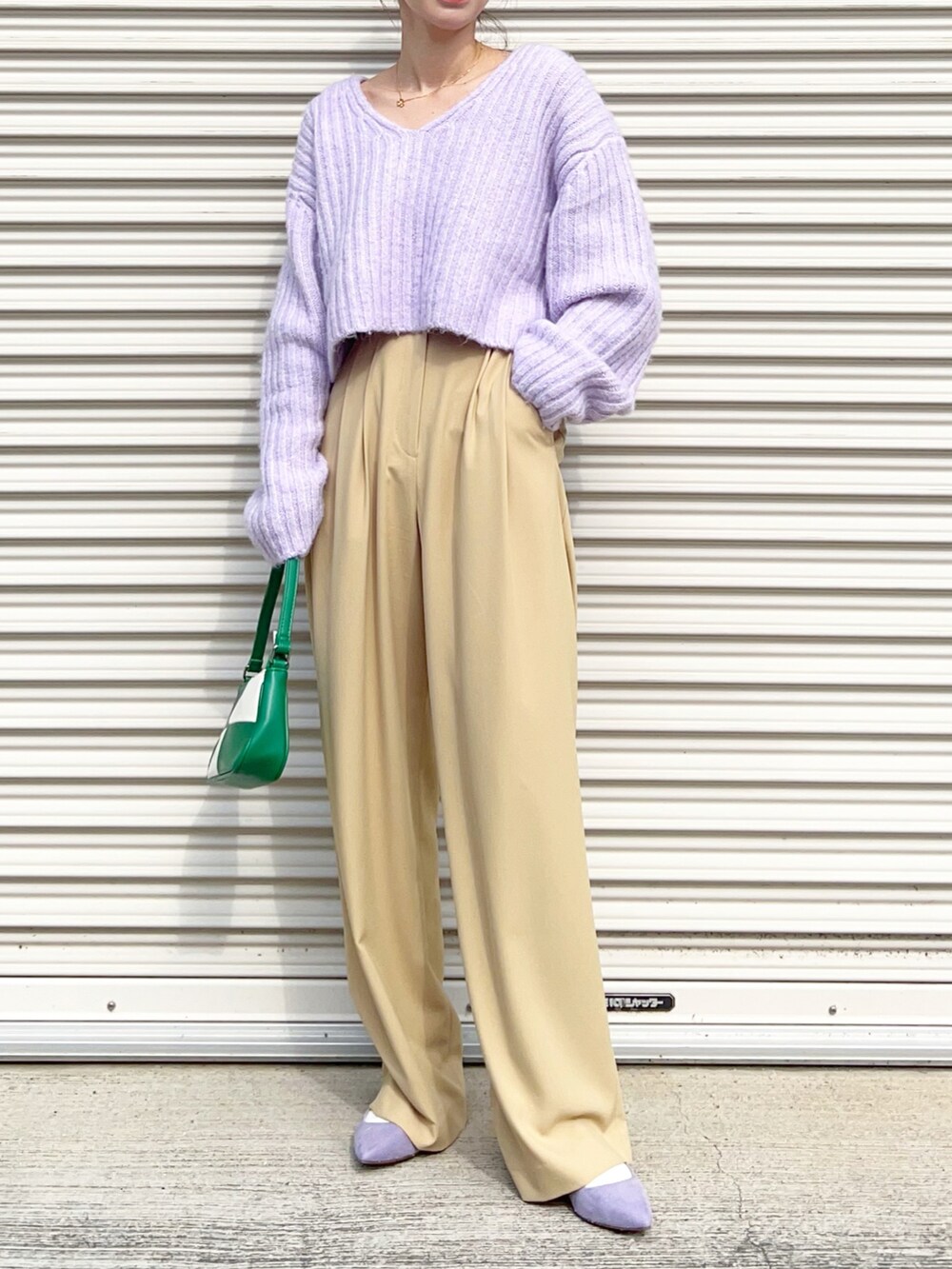 グリーン系のハンドバッグ、ベージュ系のその他パンツ、パープル系のパンプスを着用したレディースの冬コーディネートの3枚目の写真