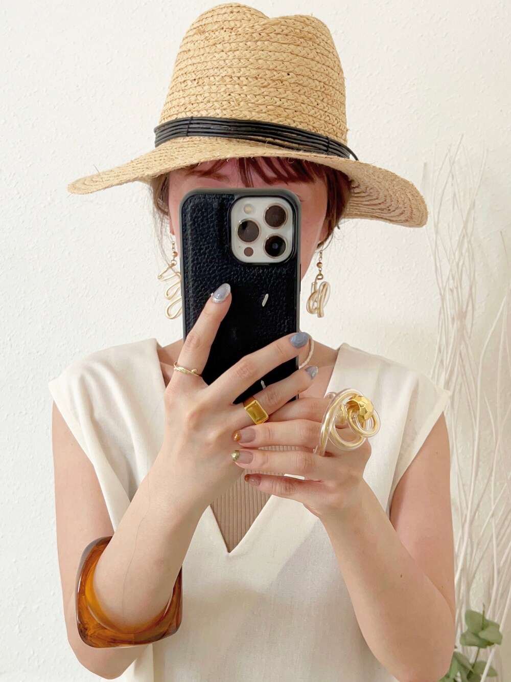 ホワイト系のベスト、ベージュ系のタンクトップ、イエロー系のトップスを着用したレディースの夏コーディネートの3枚目の写真