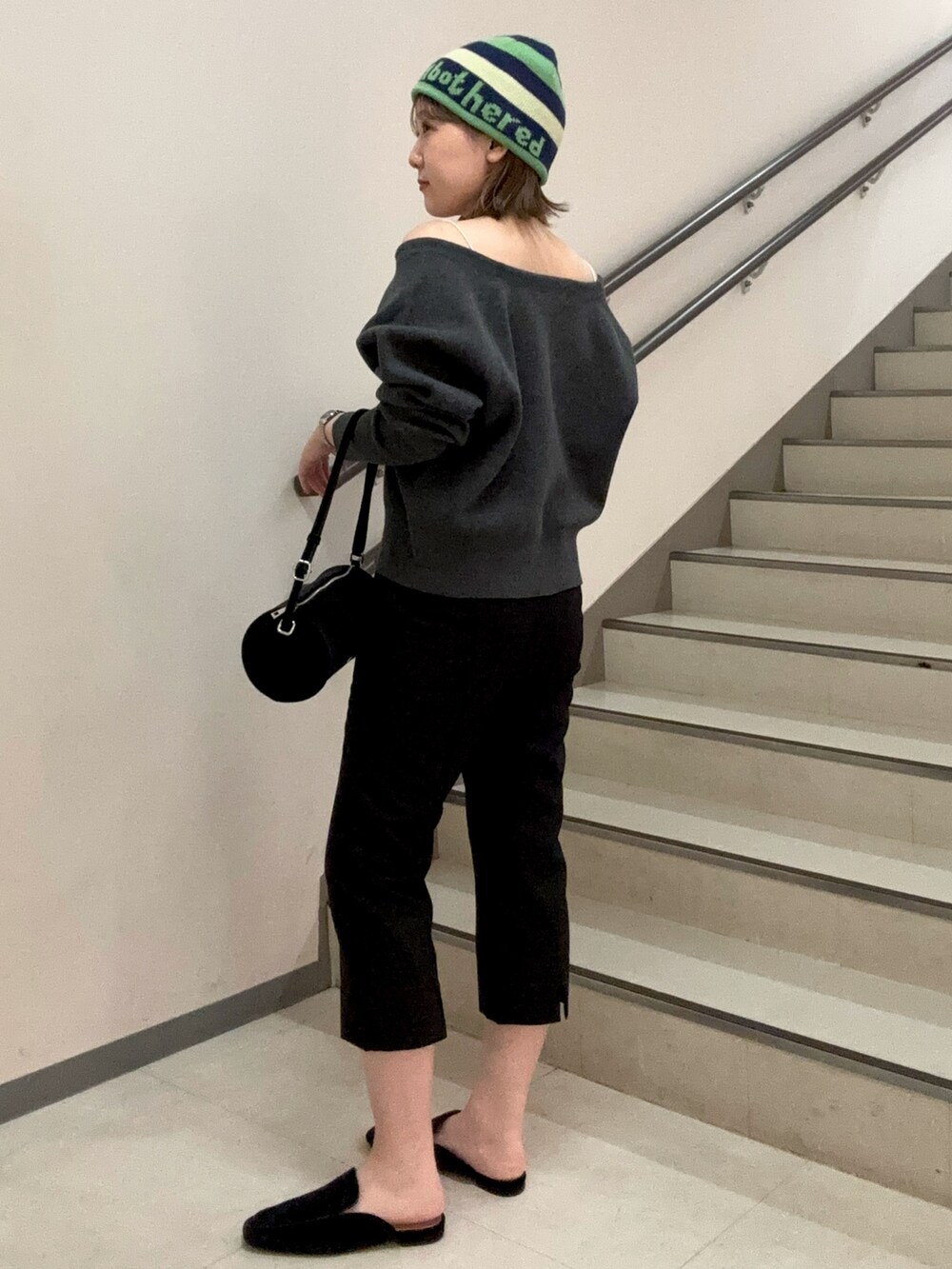 グレー系のニット/セーター、ブラック系のその他パンツ、ブラック系のその他シューズを着用したレディースの秋コーディネートの4枚目の写真