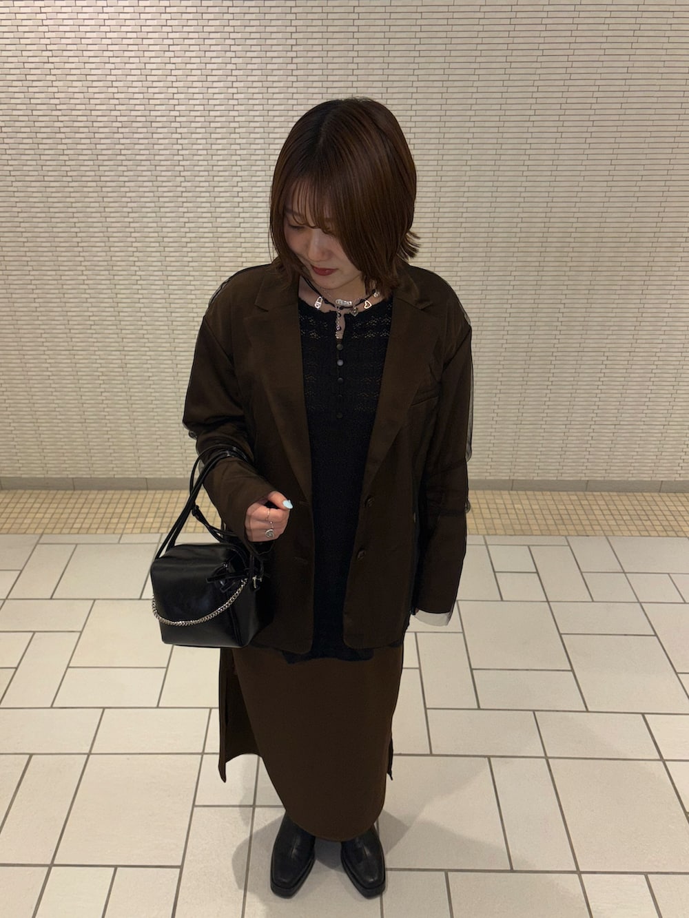 ブラウン系のその他アウター、ブラウン系のワンピース、ブラック系のTシャツ/カットソーを着用したレディースの冬コーディネートの2枚目の写真