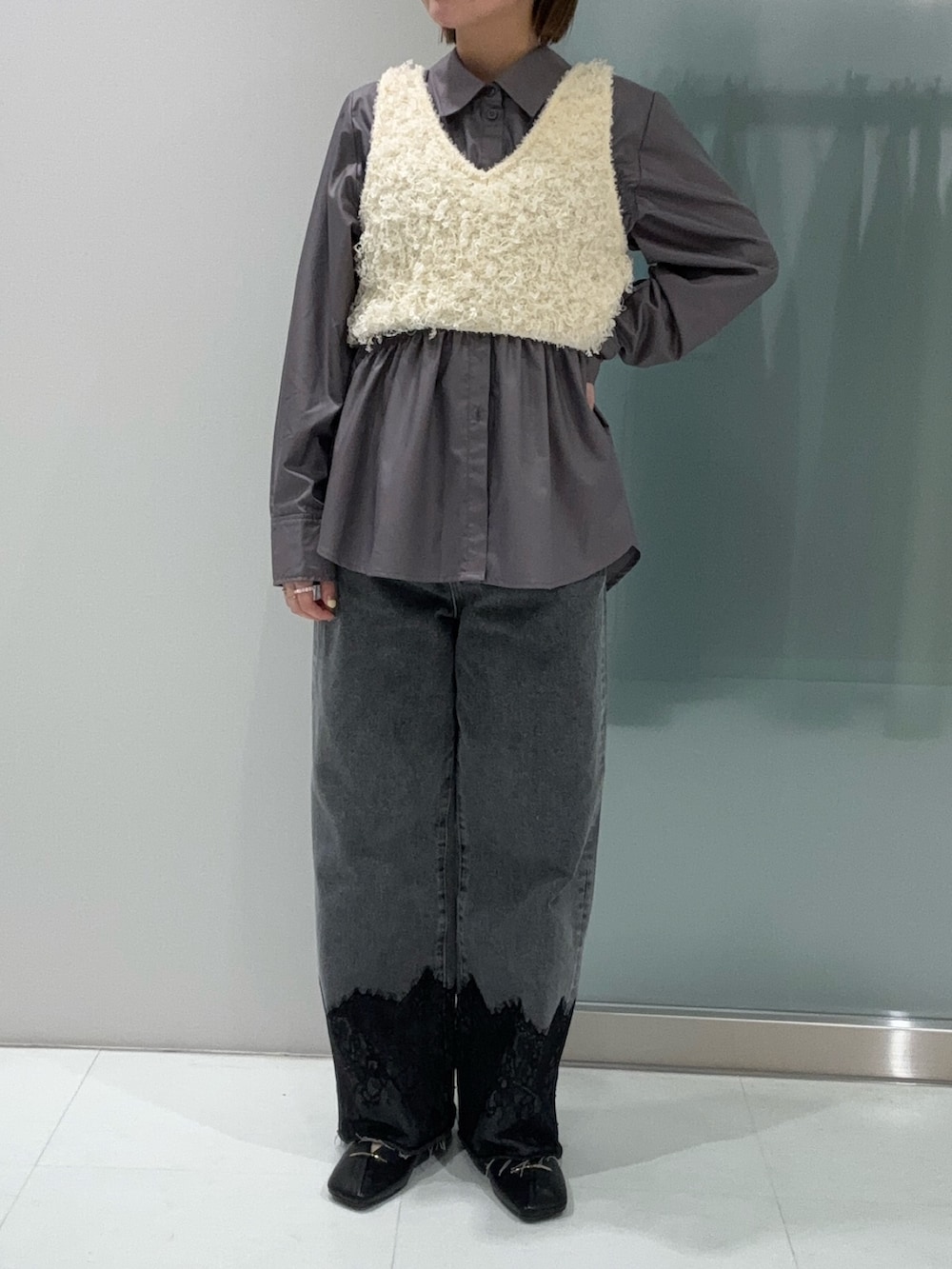 ホワイト系のシャツ/ブラウス、ホワイト系のベスト、グレー系のデニムパンツを着用したレディースの春コーディネートの3枚目の写真