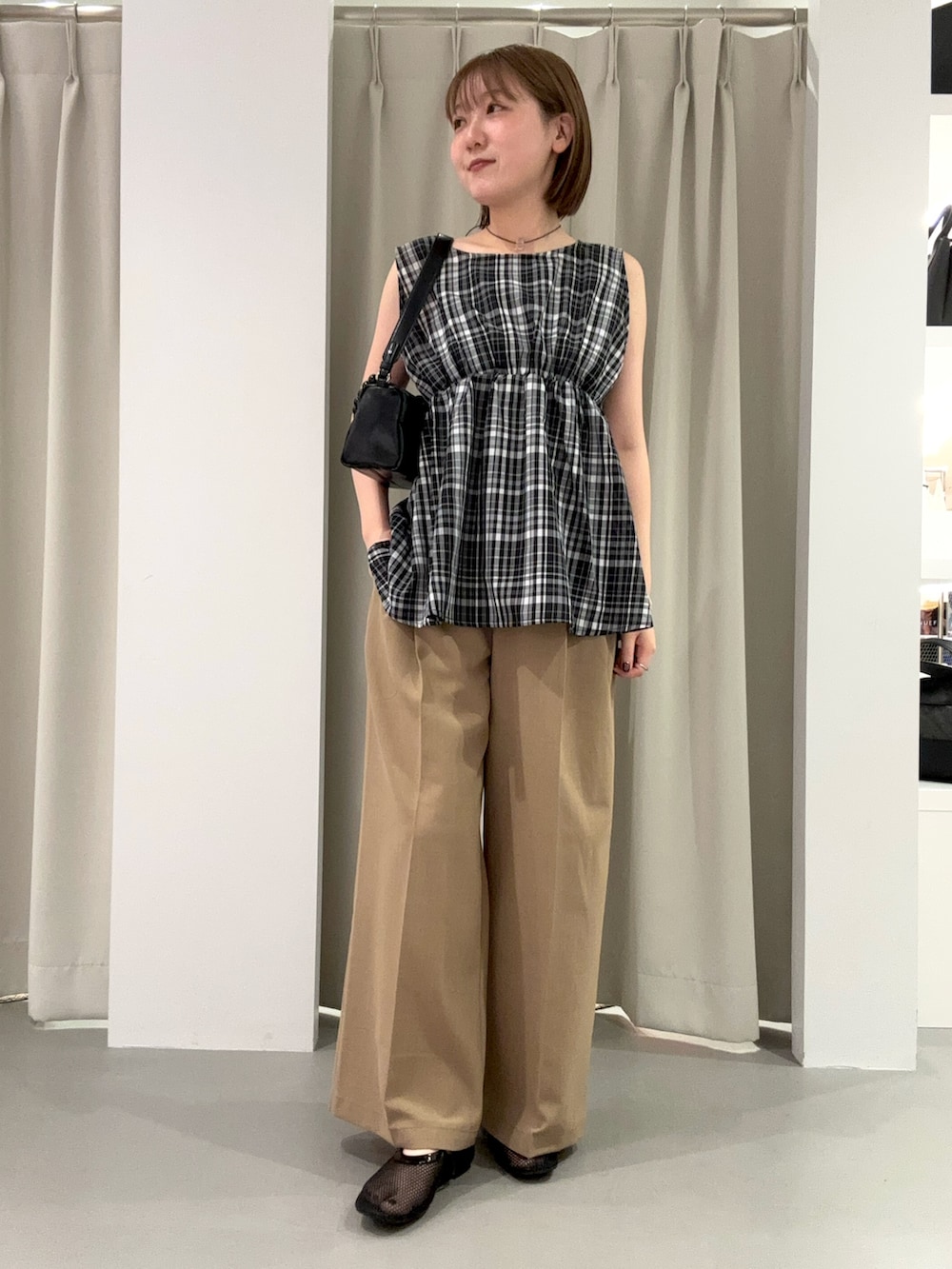ブラック系のシャツ/ブラウス、ベージュ系のその他パンツ、ブラック系のショルダーバッグを着用したレディースの夏コーディネートの2枚目の写真