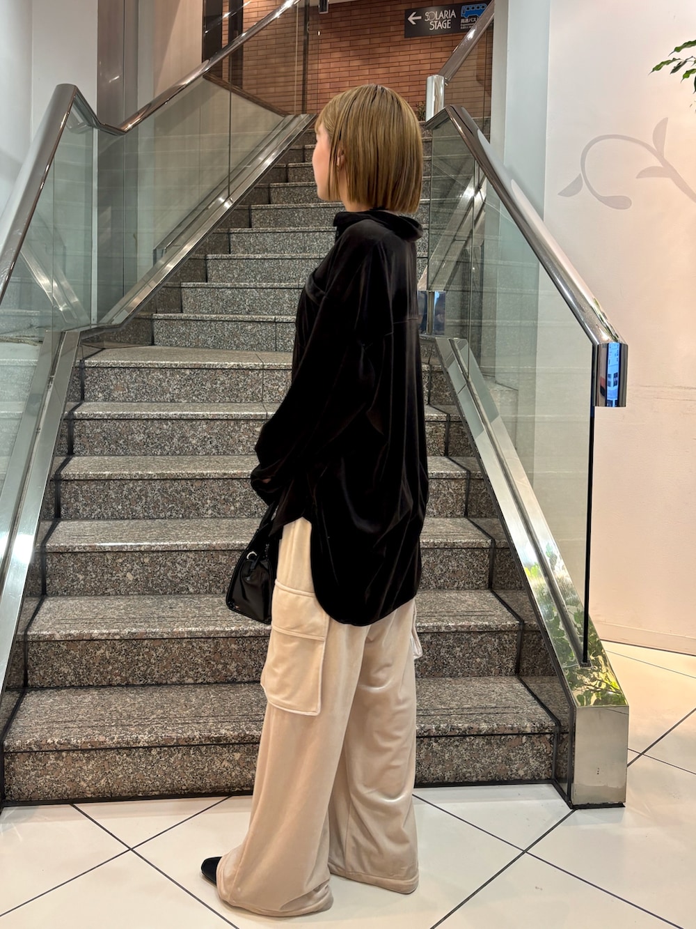 ブラック系のシャツ/ブラウス、ブラック系のボストンバッグ、ベージュ系のその他パンツを着用したレディースの冬コーディネートの5枚目の写真