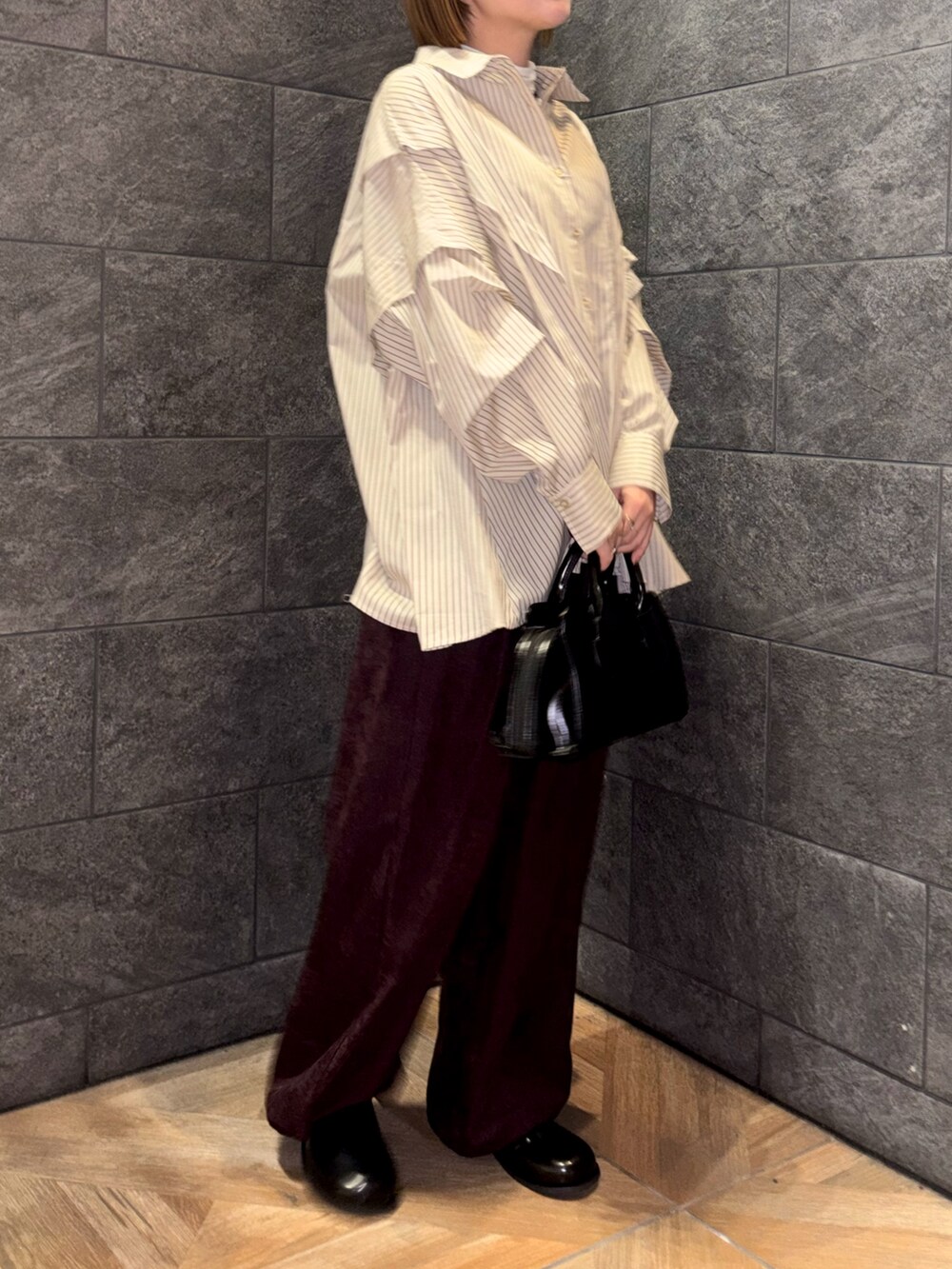 ホワイト系のTシャツ/カットソー、ベージュ系のシャツ/ブラウス、レッド系のその他パンツを着用したレディースの冬コーディネートの2枚目の写真