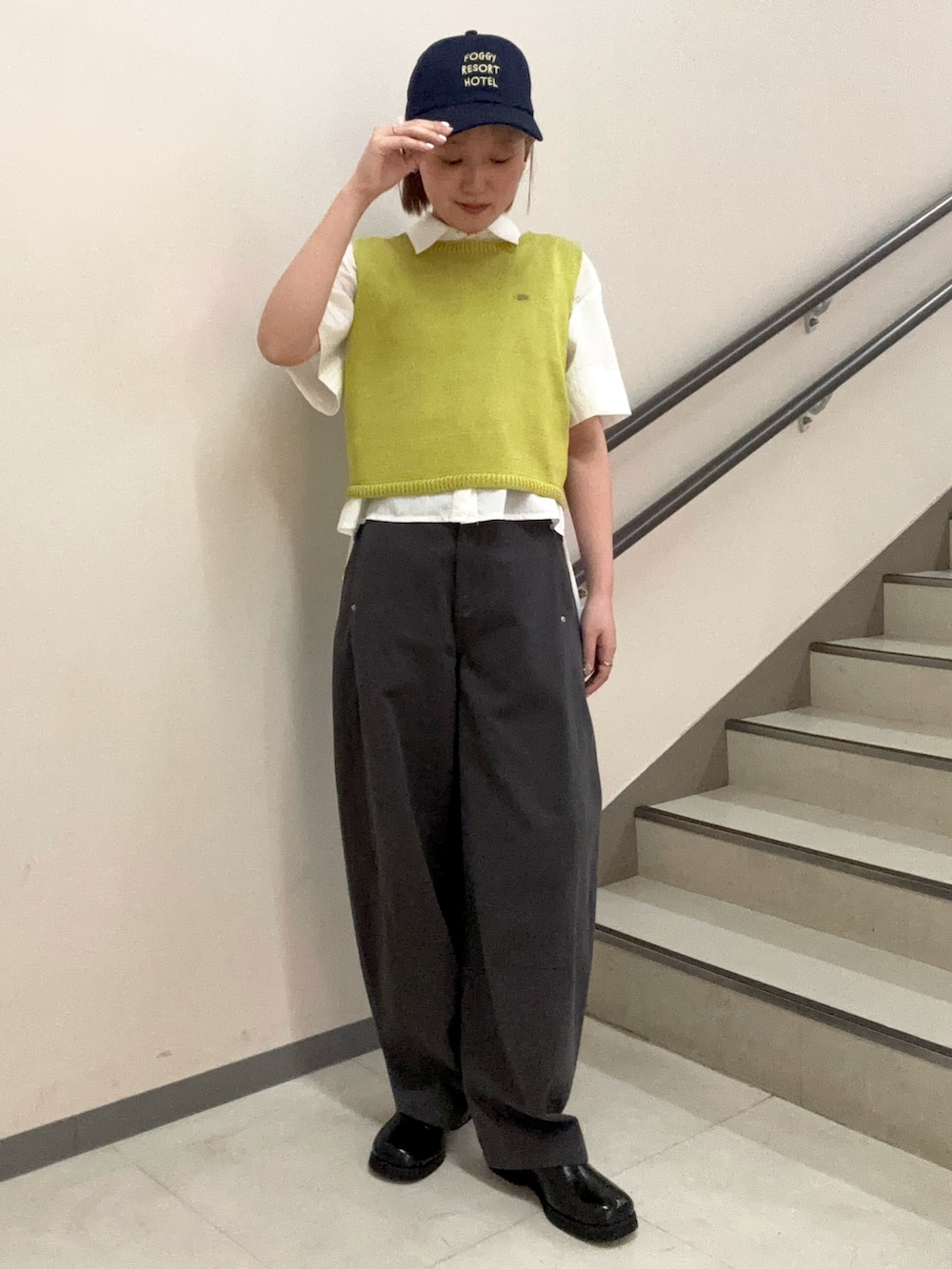 ホワイト系のシャツ/ブラウス、イエロー系のニット/セーター、グレー系のその他パンツを着用したレディースの春コーディネートの2枚目の写真