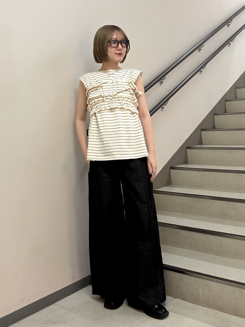 ホワイト系のTシャツ/カットソー、ブラック系のデニムパンツを着用したレディースの春コーディネートの2枚目の写真