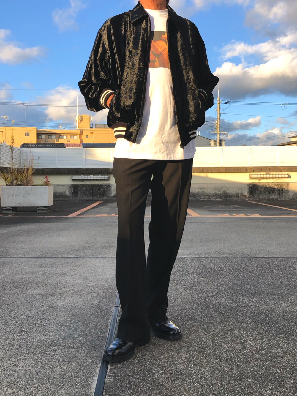 ブラック系のブルゾン、ホワイト系のTシャツ/カットソー、ブラック系のその他パンツを着用したメンズの秋コーディネートの3枚目の写真