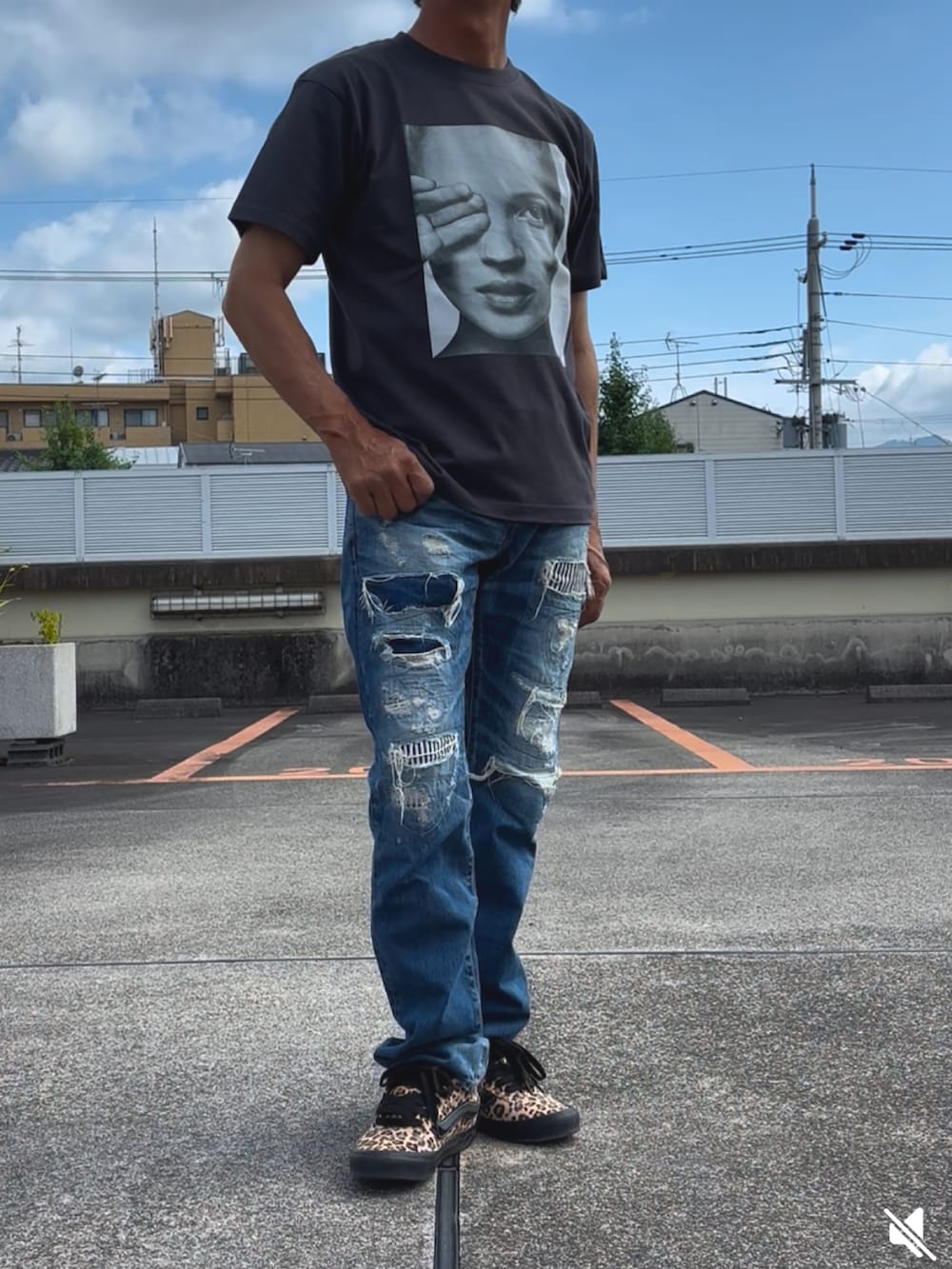 ブラック系のTシャツ/カットソー、ブラウン系のスニーカー、ブルー系のデニムパンツを着用したメンズの夏コーディネートの2枚目の写真