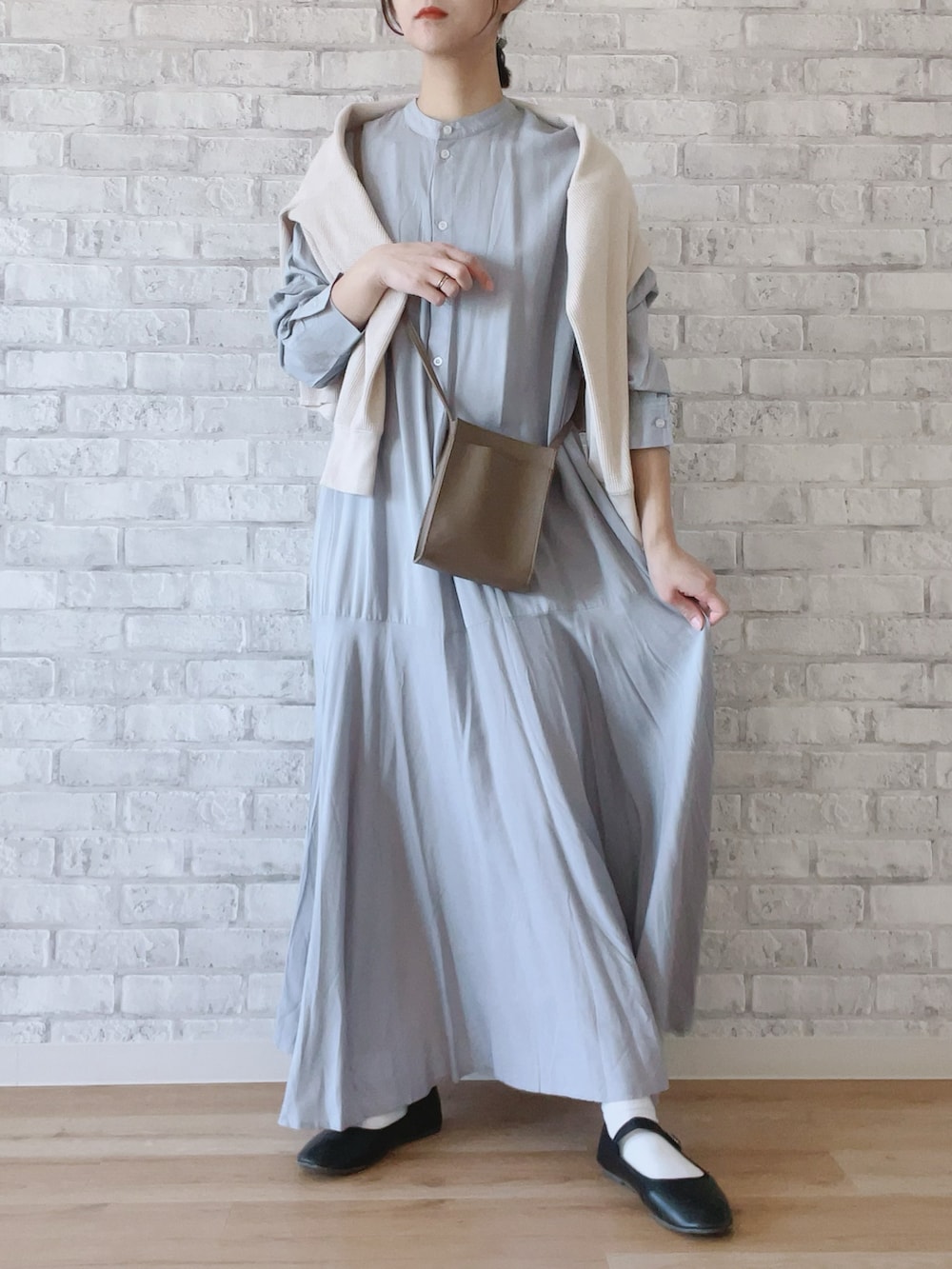 ベージュ系のTシャツ/カットソー、グレー系のシャツワンピース、ベージュ系のショルダーバッグを着用したレディースの春コーディネートの2枚目の写真