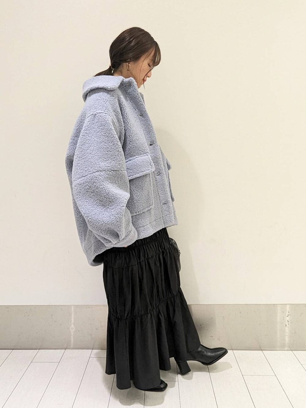 ブルー系のブルゾン、ブラック系のパンプス、グレー系のスウェットを着用したレディースの秋コーディネートの2枚目の写真