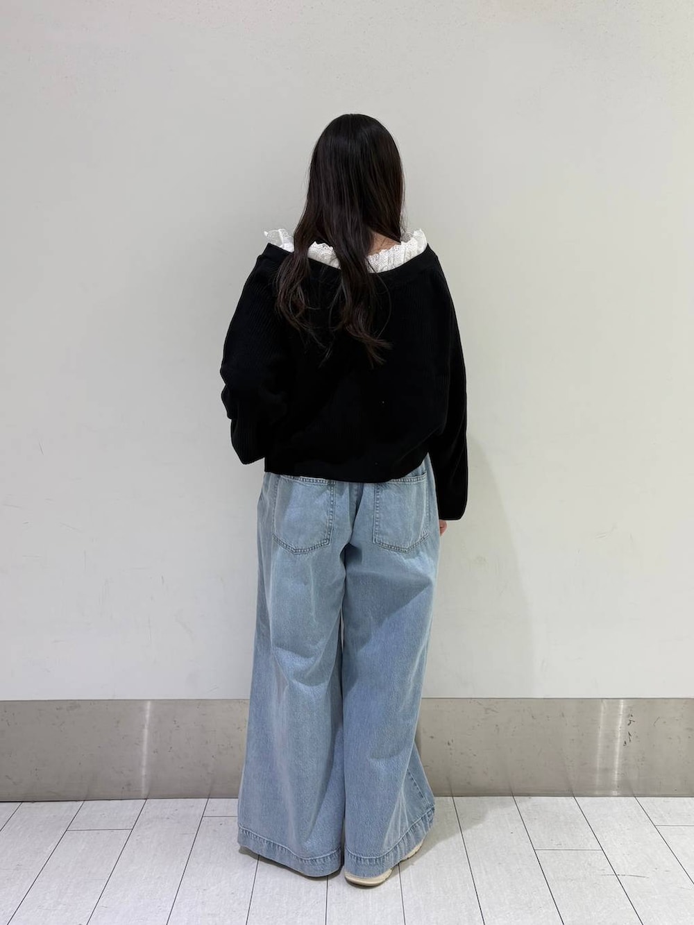 ブルー系のデニムパンツ、ブラック系のカーディガン/ボレロを着用したレディースの冬コーディネートの3枚目の写真