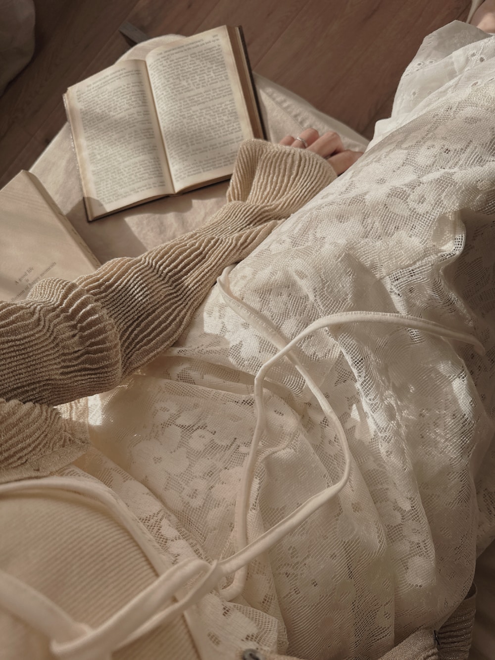 ホワイト系のワンピース/ドレス、ホワイト系のパンツ、ベージュ系のカーディガン/ボレロを着用したレディースの春コーディネートの2枚目の写真