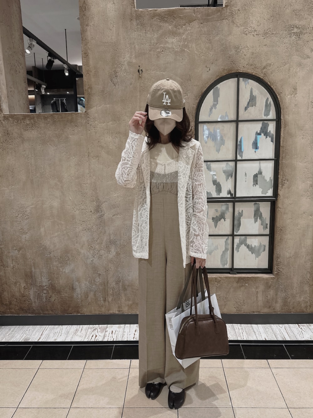 ブラウン系のサロペット/オーバーオール、ホワイト系のテーラードジャケット、ベージュ系のキャミソールを着用したレディースの春コーディネートの2枚目の写真