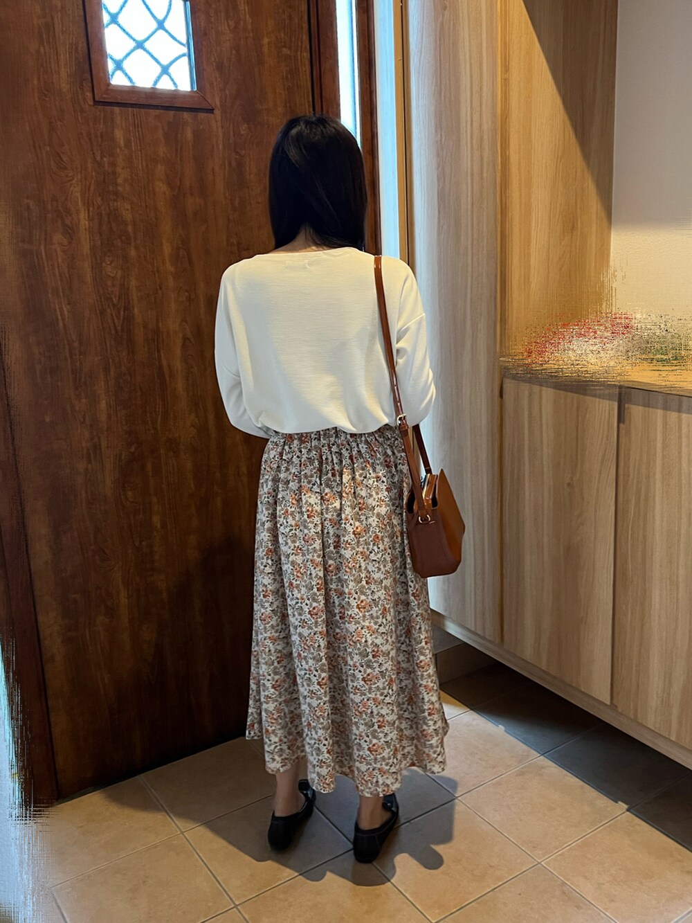 ホワイト系のスカート、ブラウン系のショルダーバッグ、ホワイト系のTシャツ/カットソーを着用したレディースの秋コーディネートの3枚目の写真