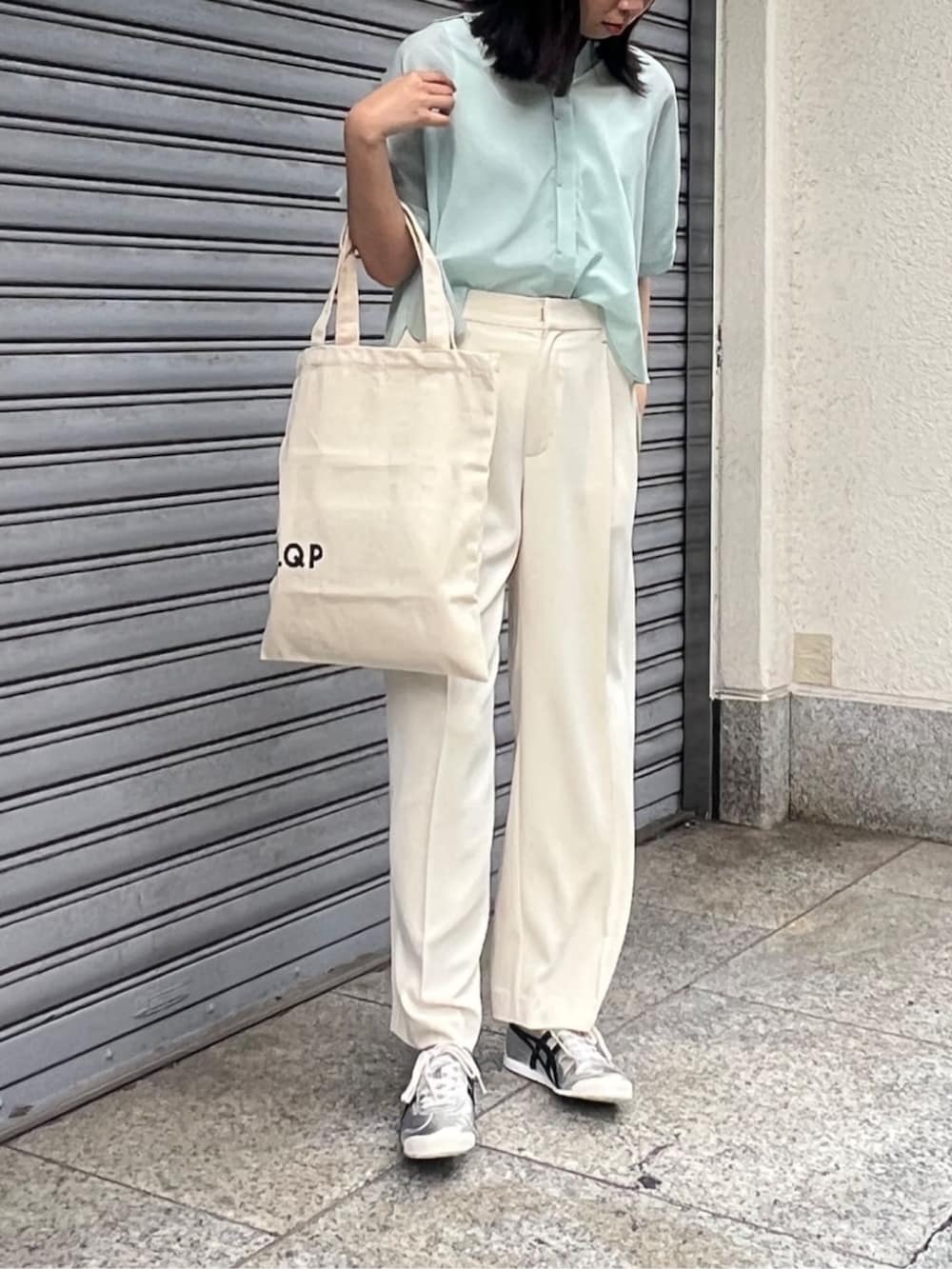ベージュ系のその他パンツ、グリーン系のシャツ/ブラウス、シルバー系のスニーカーを着用したレディースの夏コーディネートの3枚目の写真